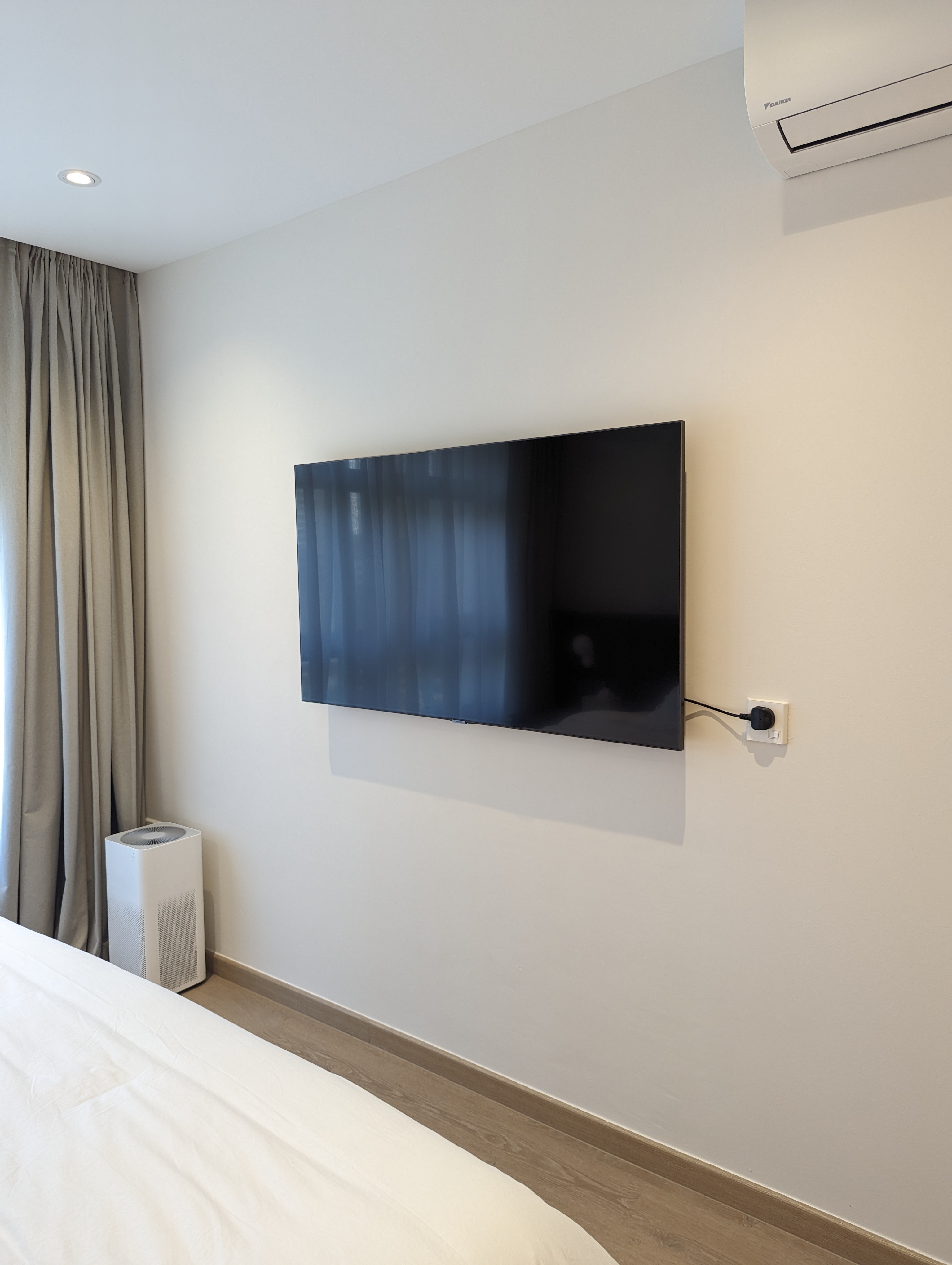 Bedroom: Our cosy sanctuary  - Modern minimalist bedroom, sleek black TV, wall-mounted TV, light-colored walls, wooden floor