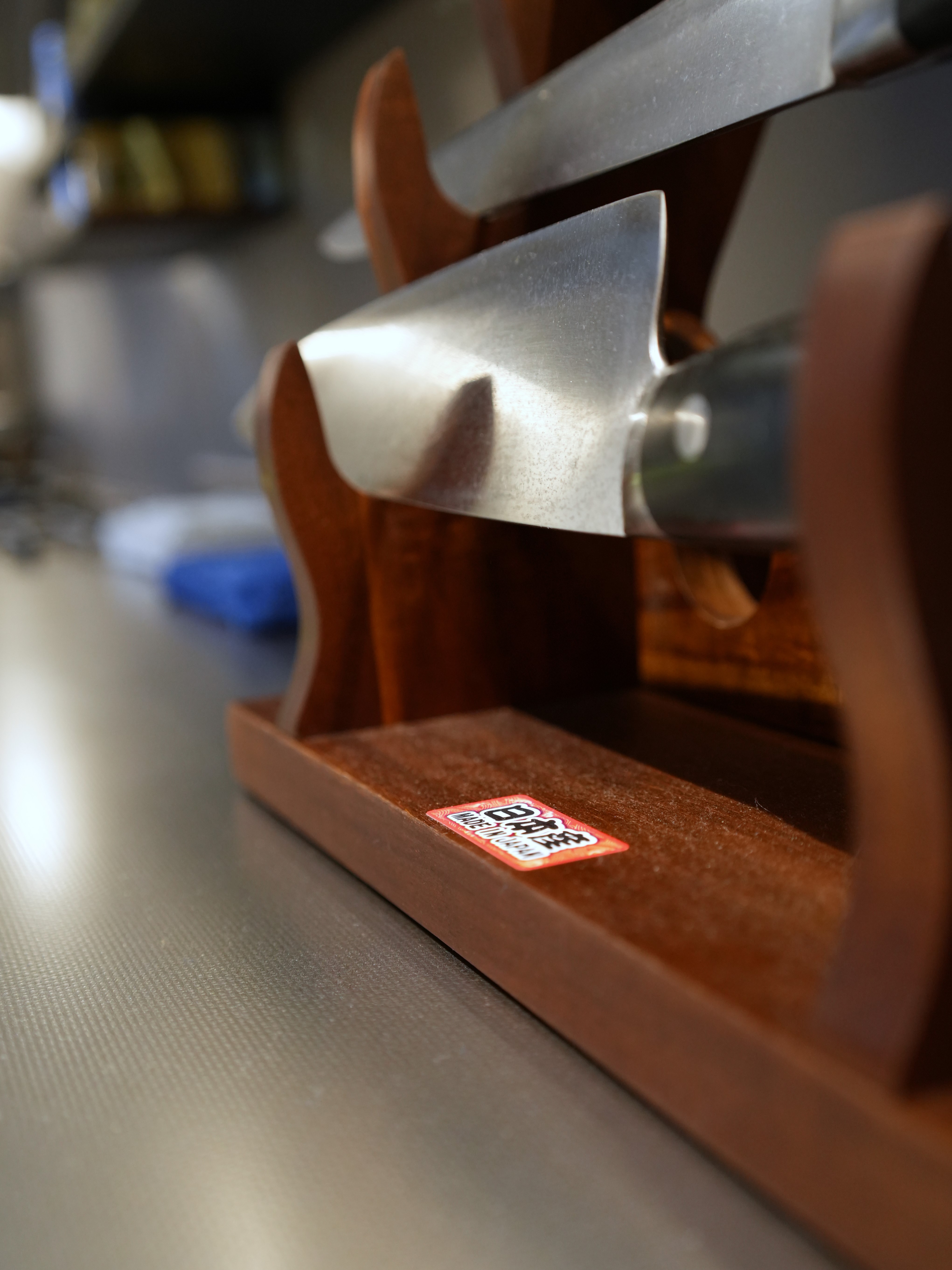 A Chef's Kitchen: Stainless Steel & Japanese Monotonal Design - Japanese knife sharpener, wooden handle, metallic blade, red