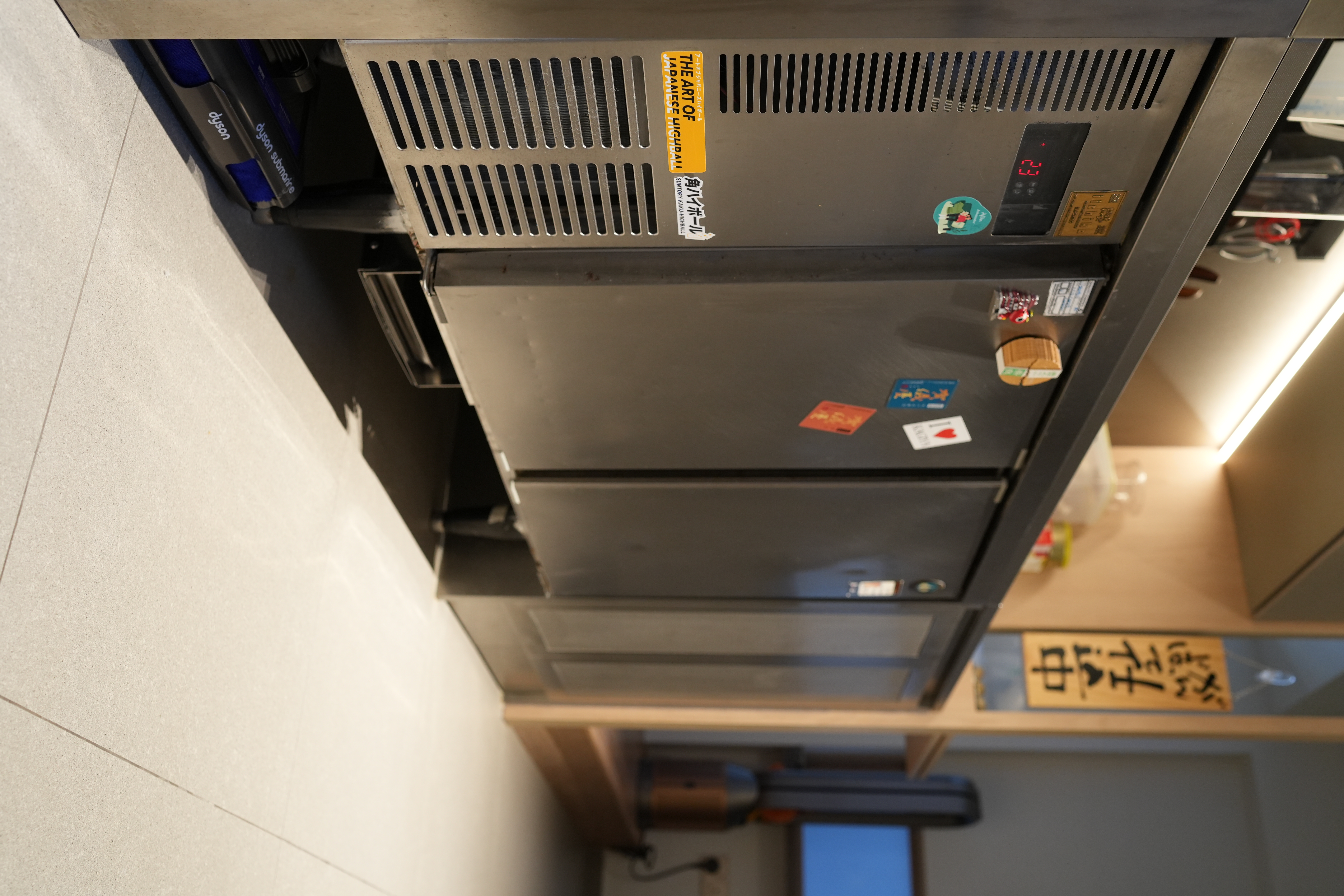 A Chef's Kitchen: Stainless Steel & Japanese Monotonal Design - Stainless steel refrigerator with ventilation grills