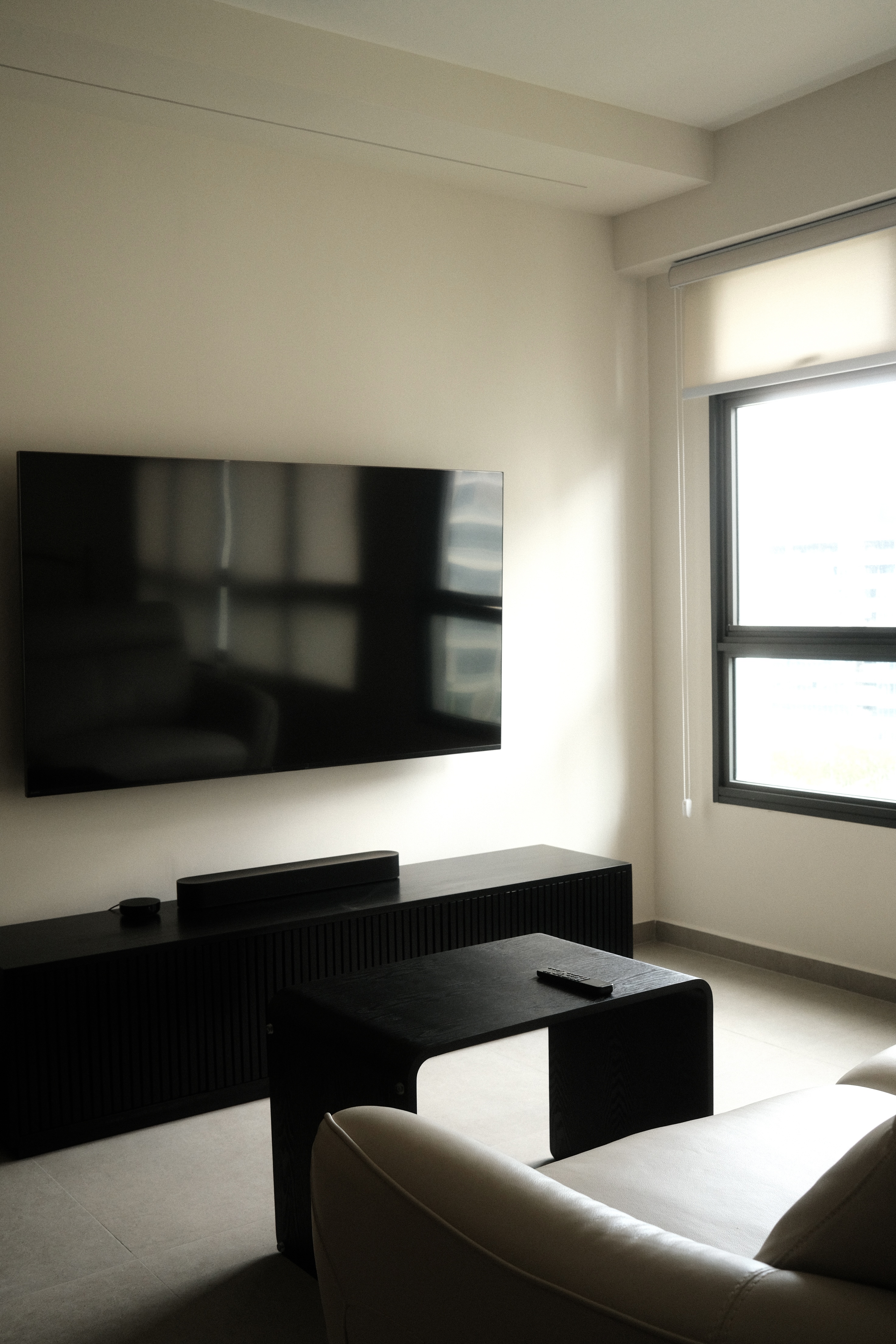Japandi Living Room with Clean, Neutral Colours - Modern minimalist living room, sleek black TV stand, large window with