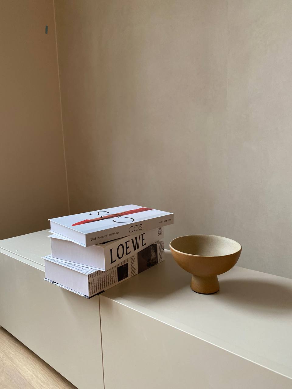 Living Room: Modular furniture increases customizability - Minimalist book stack, modern interior, neutral wall, stacked