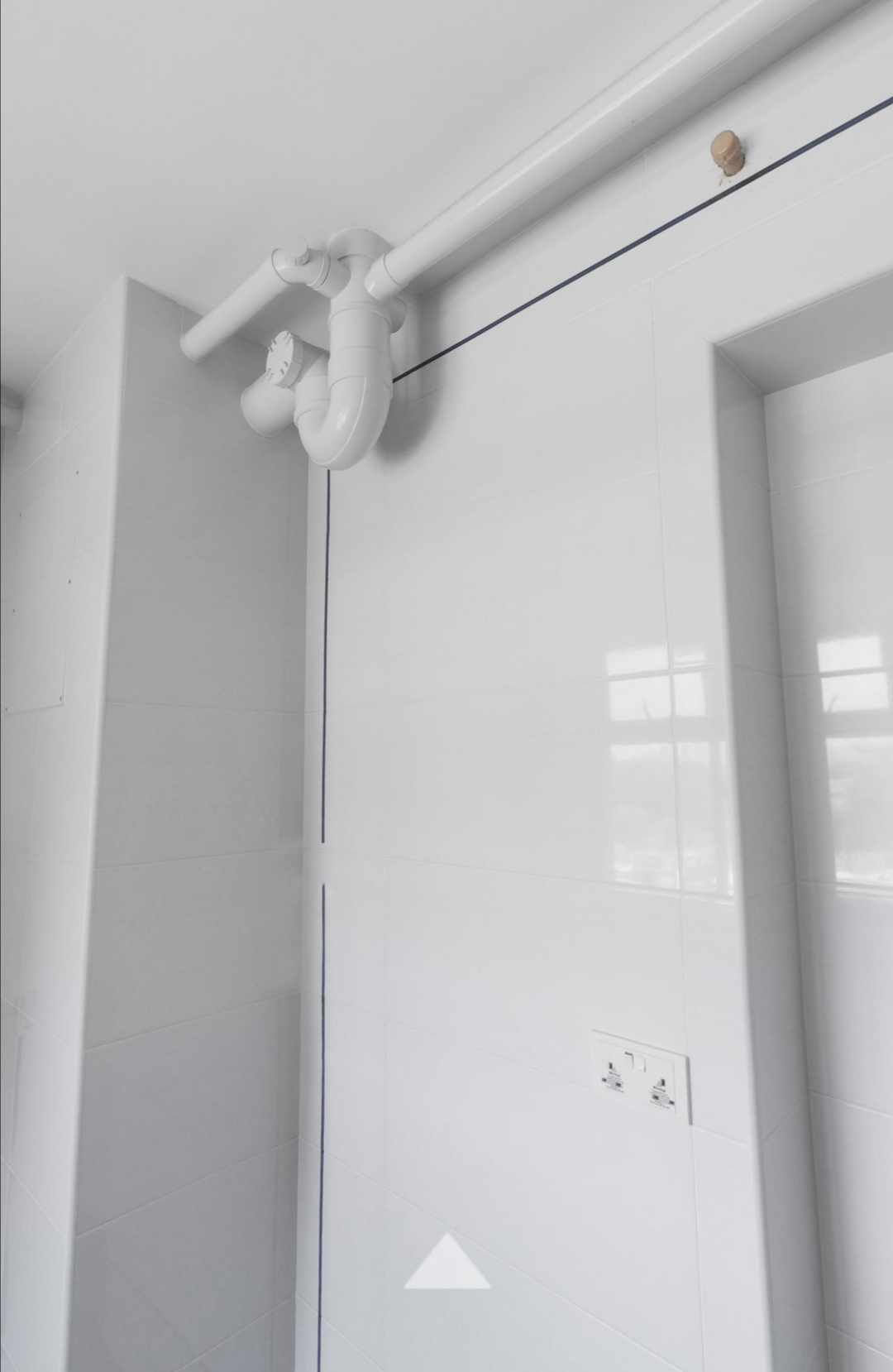 Achieving Our Kitchen Goals Despite A Little Hiccup! - White tiled bathroom, modern shower fixtures, white pipes, sleek