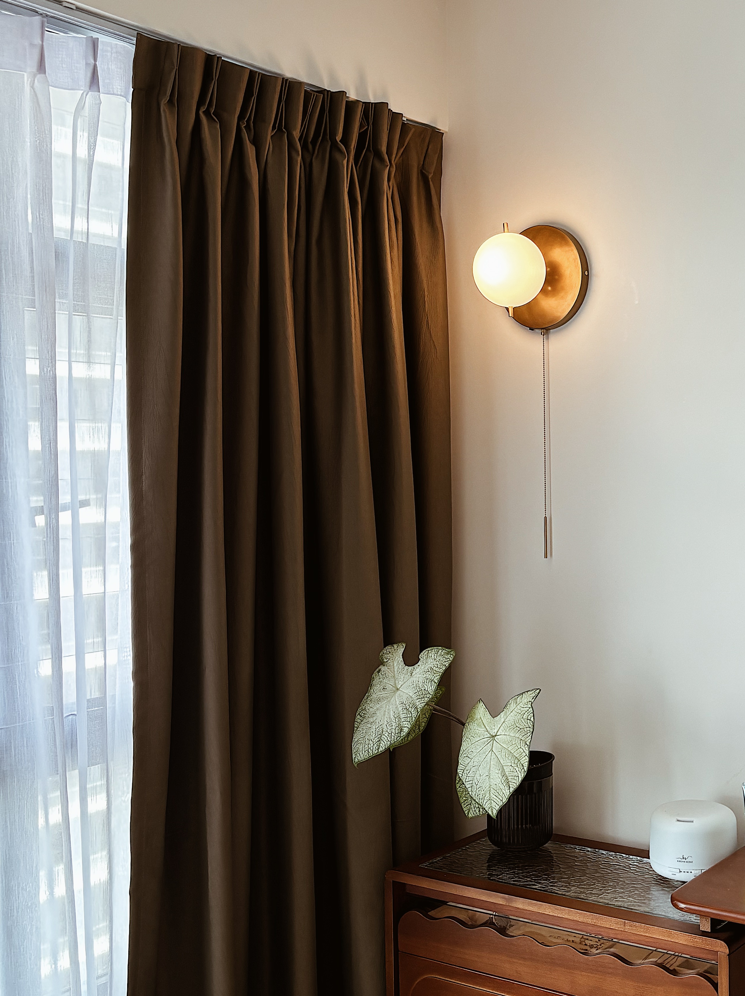 Vibe them up with ambient lighting! - Brown curtains, sheer white curtains, natural light, indoor setting, modern decor, cozy