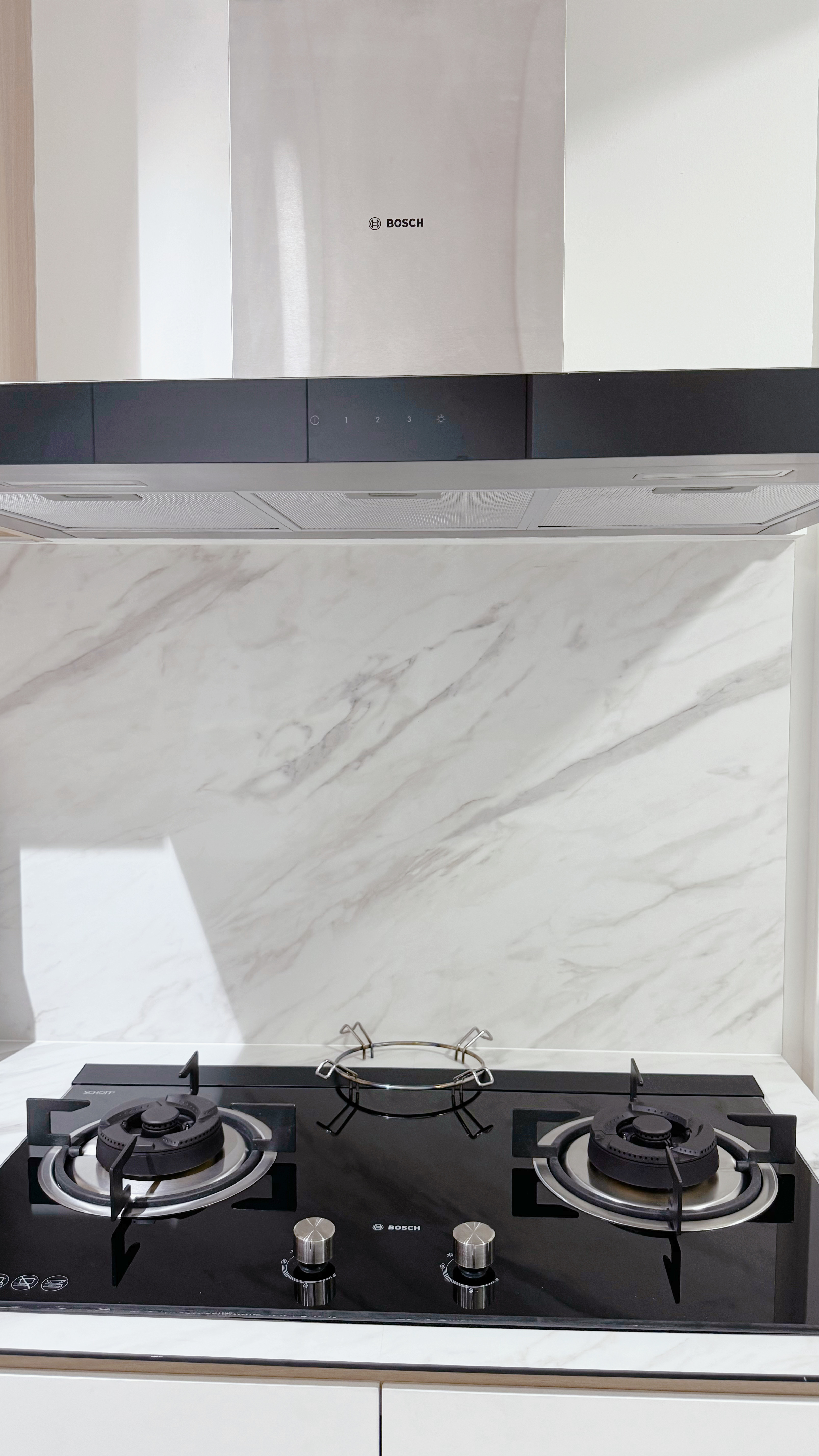 MasterChef Singapore: The Tofu Edition! - Modern kitchen stove, Bosch brand, black and silver design, marble backsplash