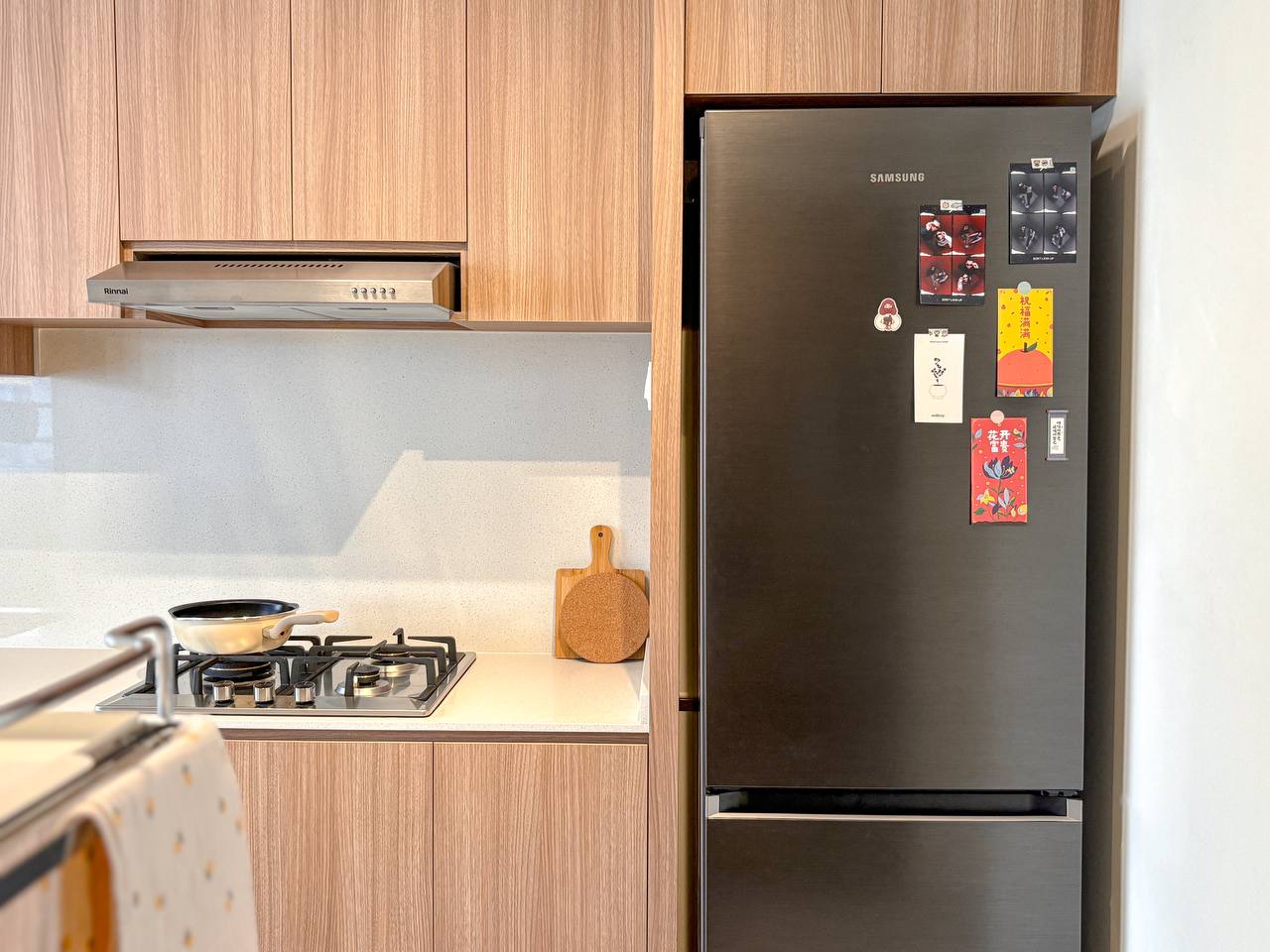 Our Favourite Part - The Kitchen! - Wooden cabinets, stainless steel range hood, black Samsung refrigerator, decorative