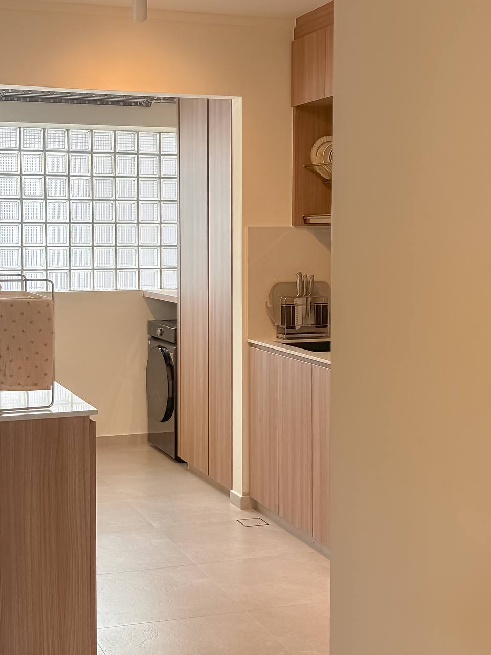 Our Favourite Part - The Kitchen! - Wooden cabinetry, modern kitchen, tiled floor, light beige walls, built-in oven