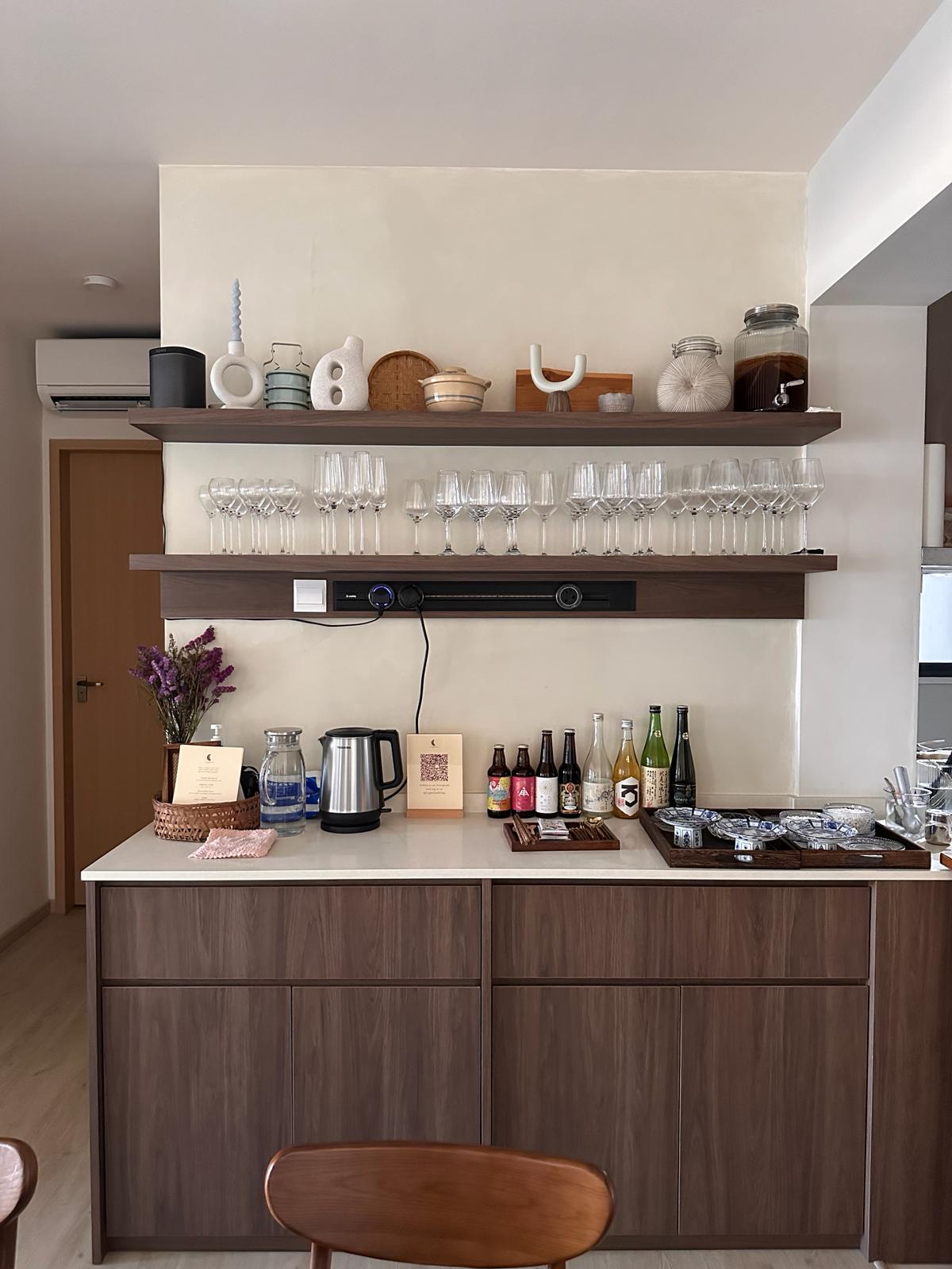 Our Dining Room: A space to gather, dine and share the joy of food. - Wooden kitchen counter, modern cabinetry, wine glasses