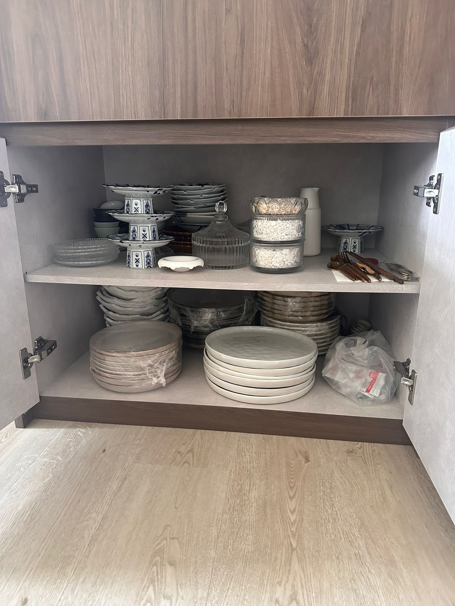 Our Dining Room: A space to gather, dine and share the joy of food. - Cabinet shelves, ceramic dishes, stacked plates, glass
