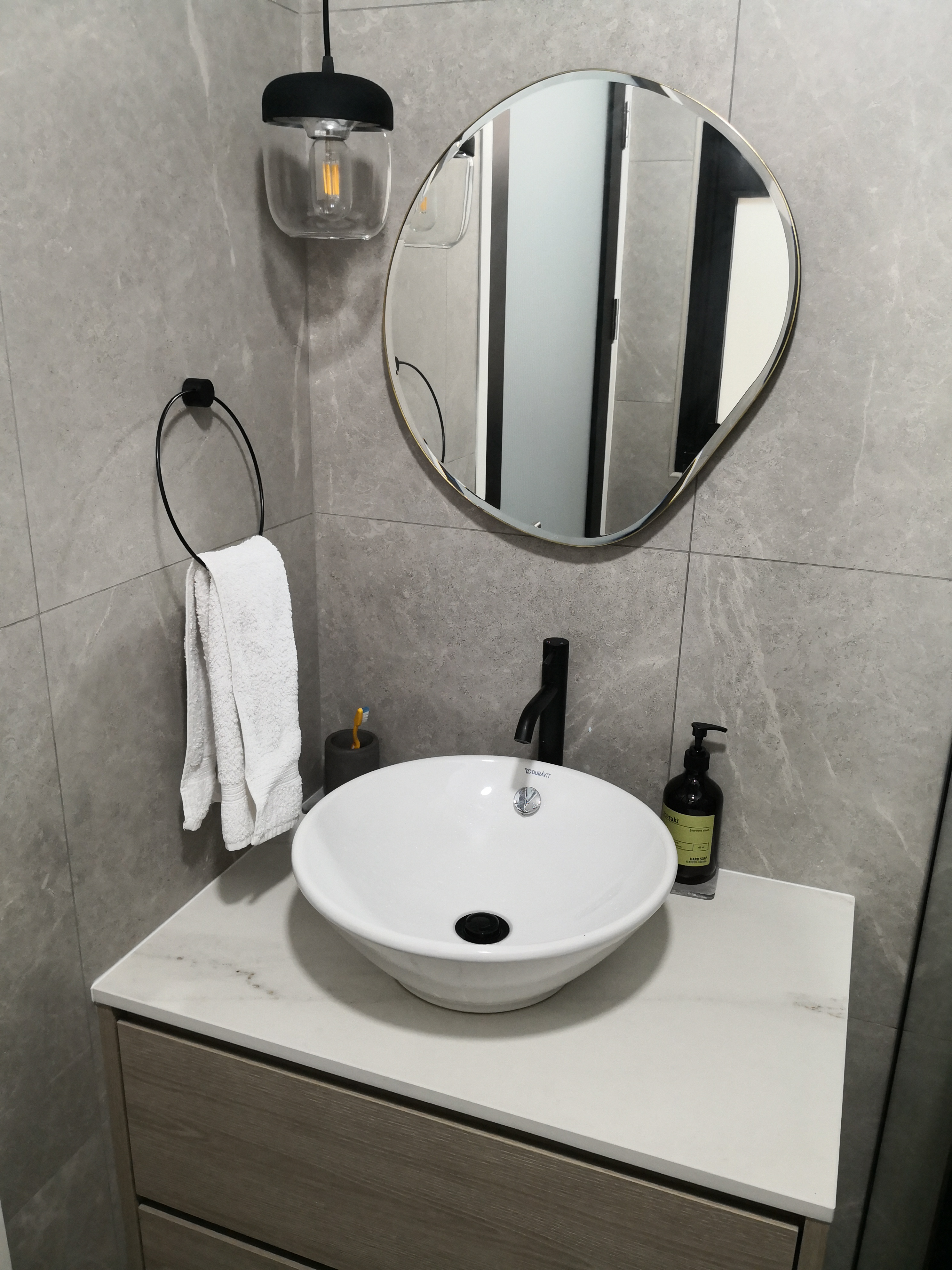 "Oh You Have 3 Bathrooms?!" - Modern bathroom vanity, sleek sink, white porcelain basin, black faucet, gray marble