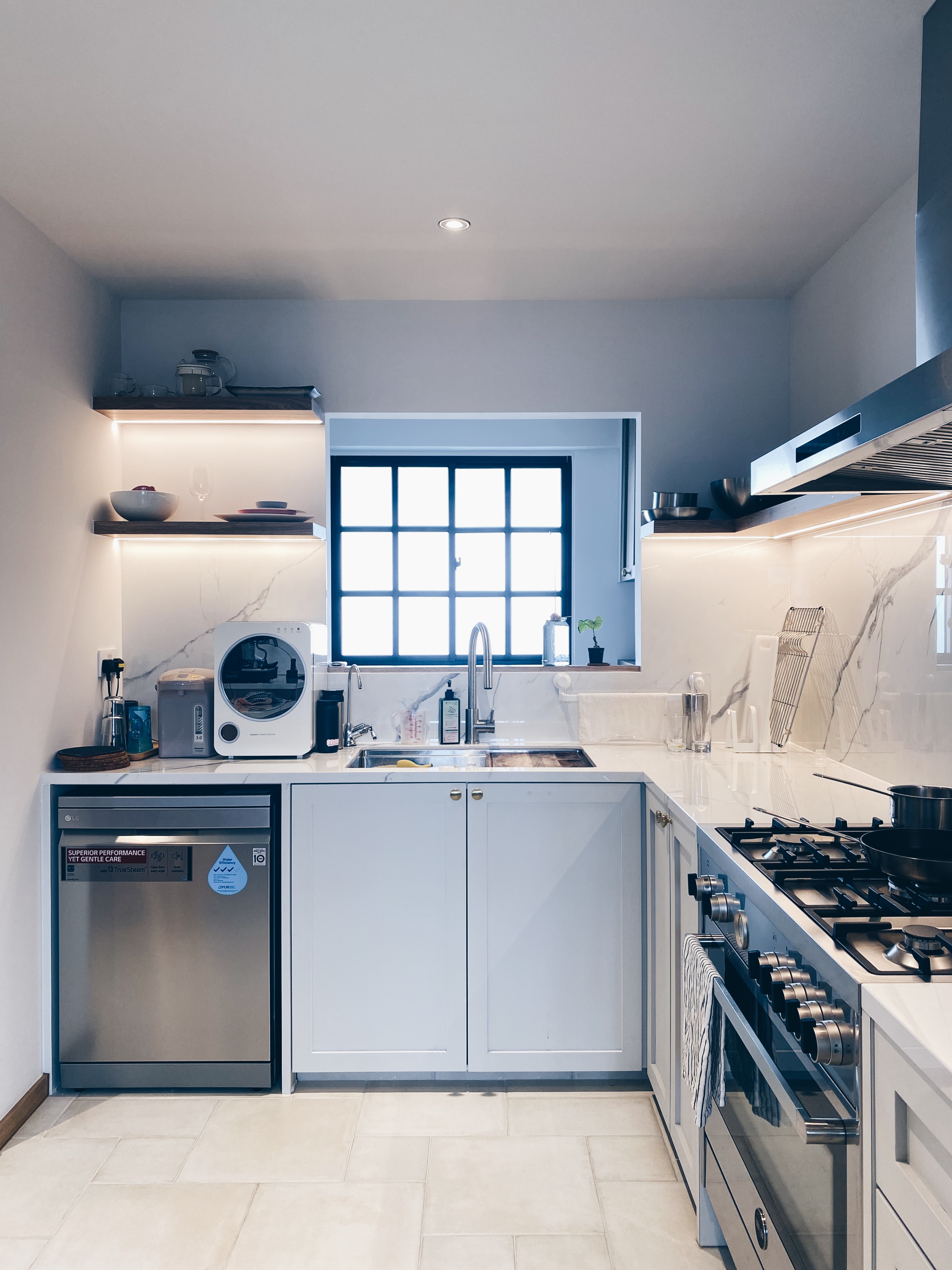 I love a white kitchen, it’s ruining my life, UNTIL ... - Modern kitchen with sleek white cabinetry, stainless steel