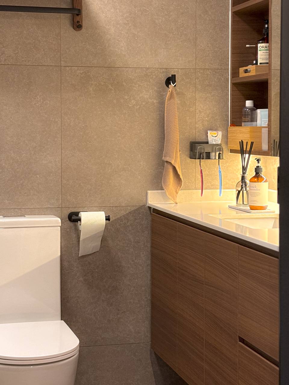 Our Biggest Reno Regrets and Reno Wins - Both in the Bathrooms - Modern bathroom with beige tiles, white toilet, wooden