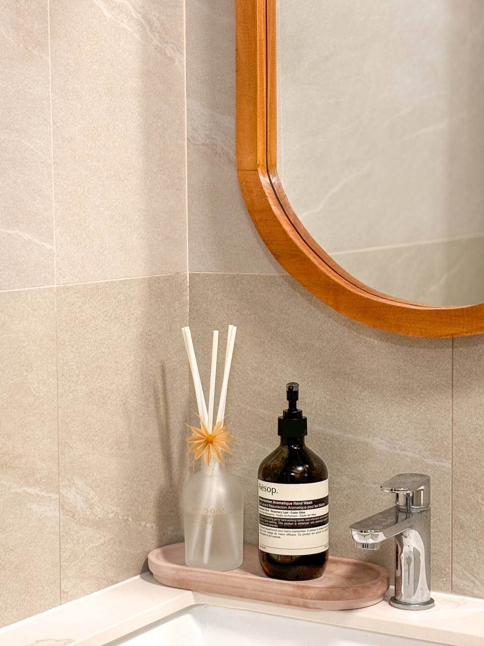 Our Biggest Reno Regrets and Reno Wins - Both in the Bathrooms - Bathroom vanity, wooden mirror, beige tiles, clear glass