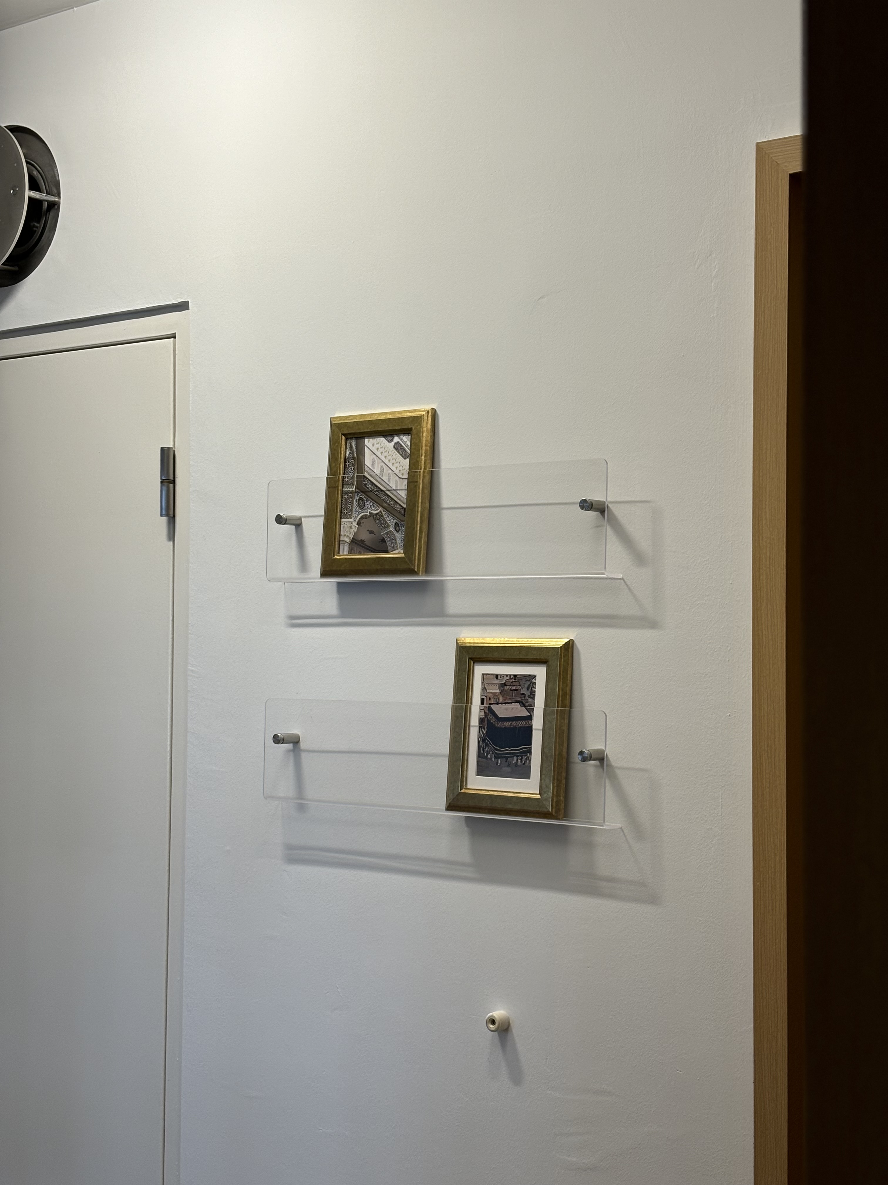 Our Simple & Cosy Living Room - White wall, minimalist design, two framed pictures, clear acrylic frames, gold frames, white