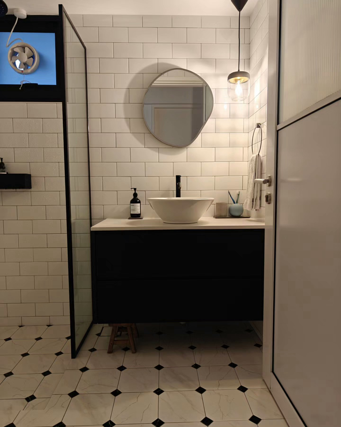 "Oh You Have 3 Bathrooms?!" - Modern bathroom with sleek design, white tiled walls and floor, black vanity with white sink