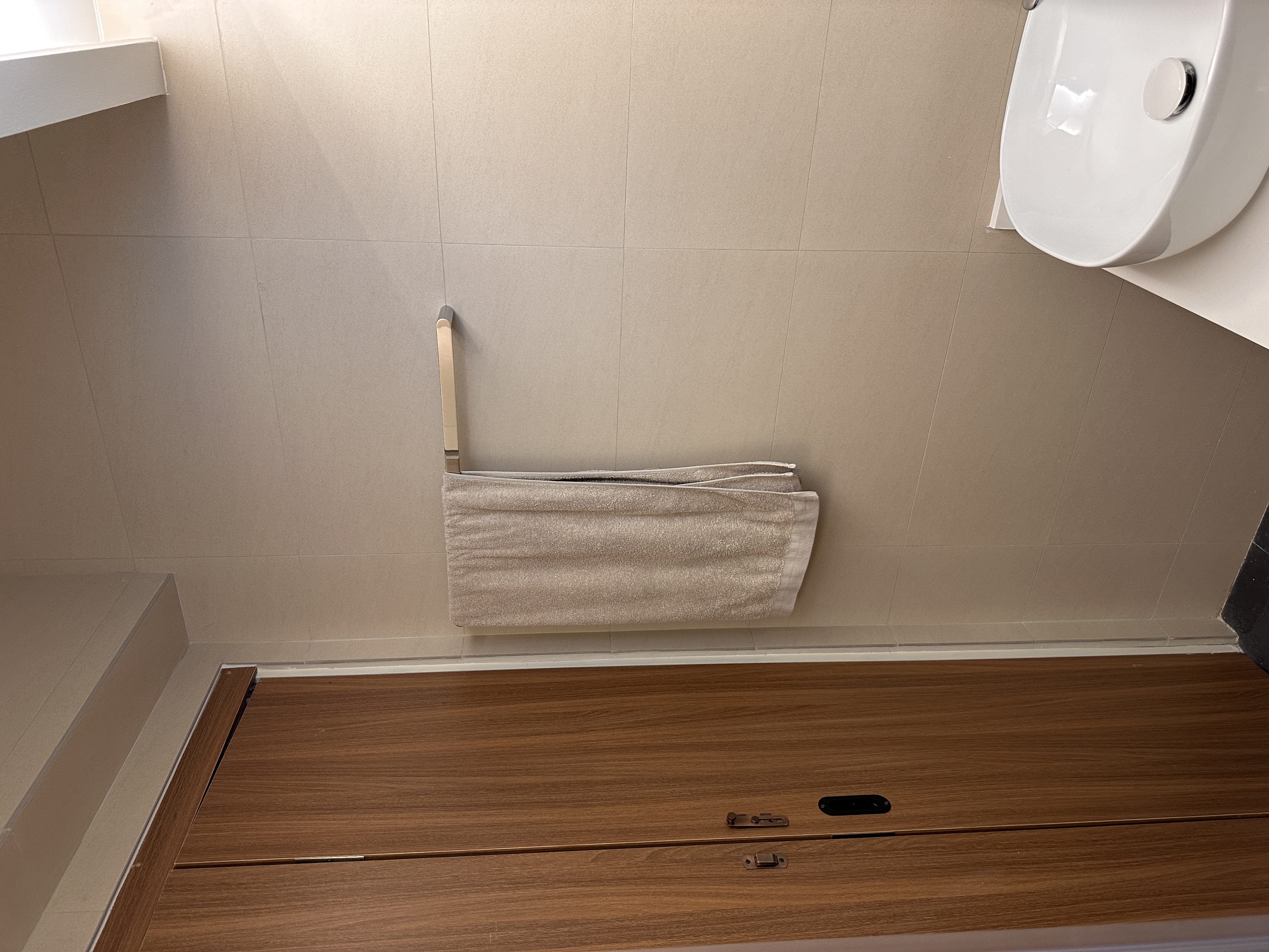 Our toilets - minimal yet functional, just the way we love! - White towel, beige wall, wooden floor, modern bathroom, clean