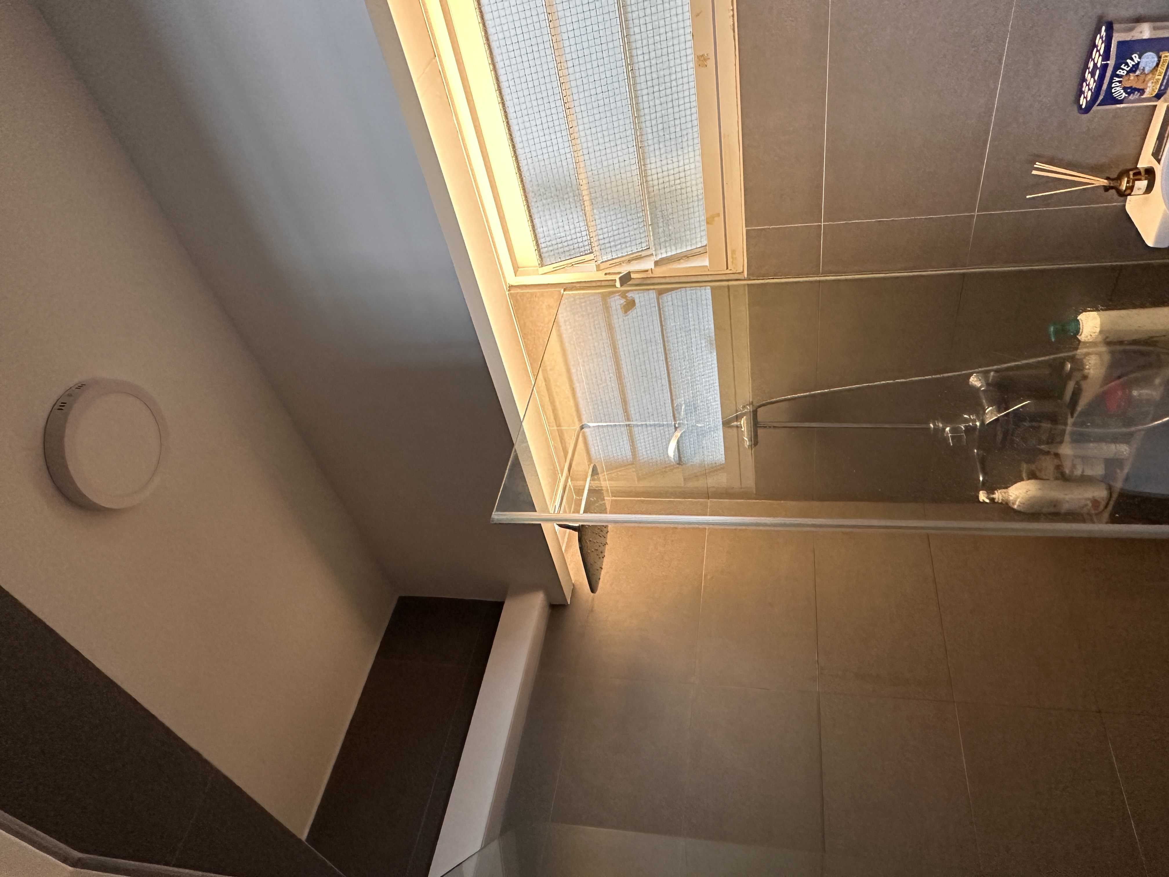 Our toilets - minimal yet functional, just the way we love! - Modern bathroom, tiled floor, sleek design, large window