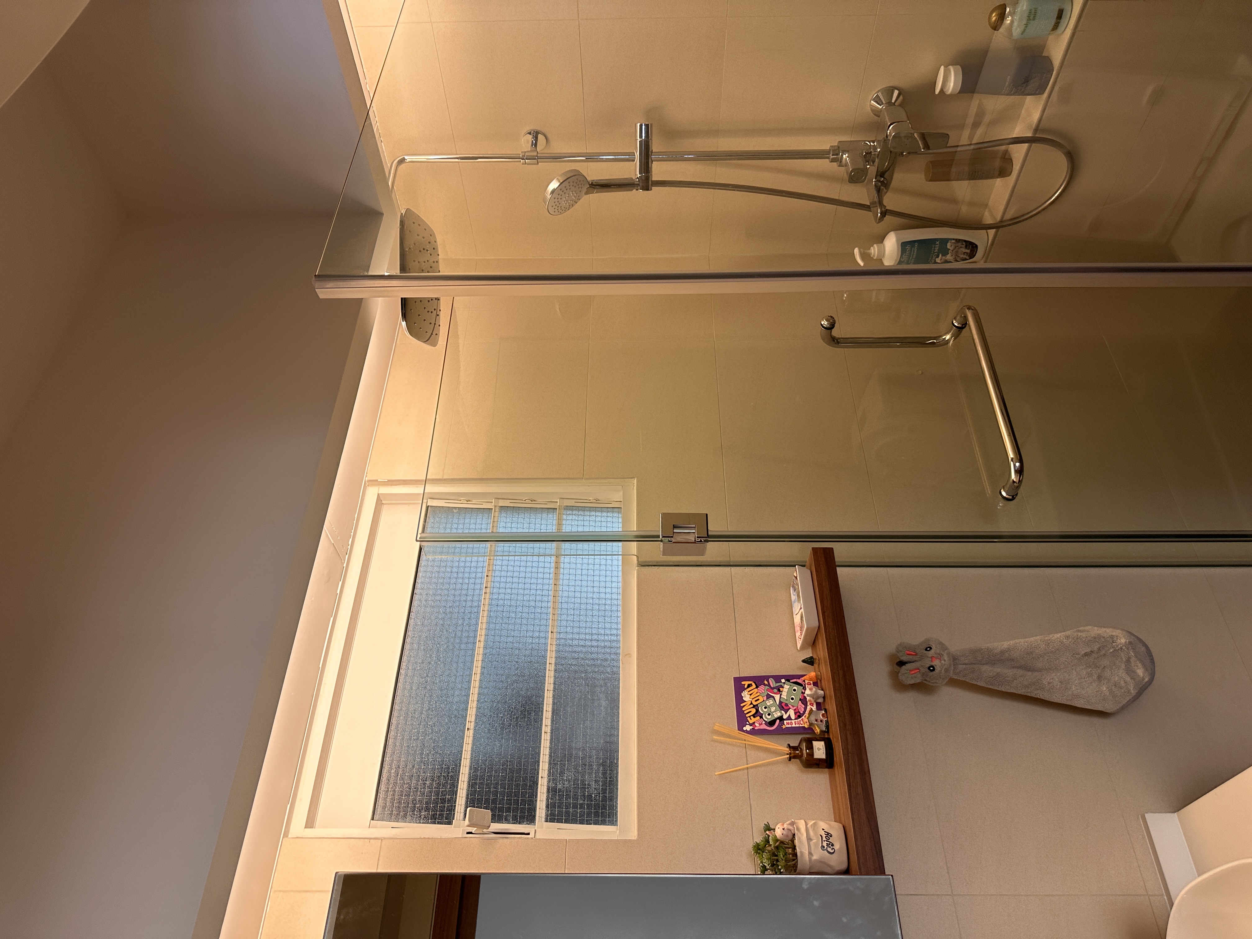 Our toilets - minimal yet functional, just the way we love! - glass shower enclosure, modern design, beige tiles, showerhead