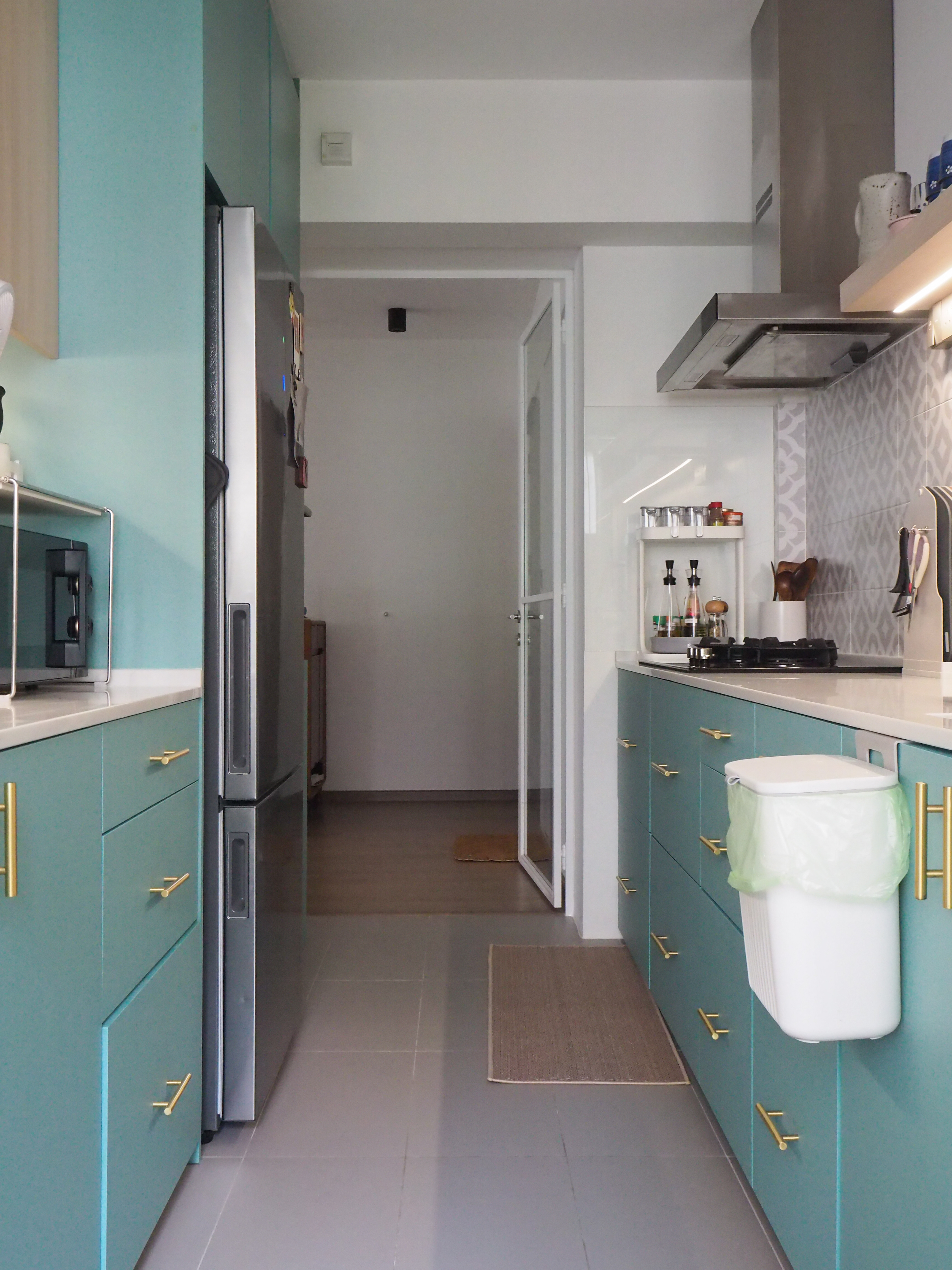 Our Galley Kitchen: 5 best reno decisions  - Turquoise kitchen cabinets with gold handles, stainless steel refrigerator