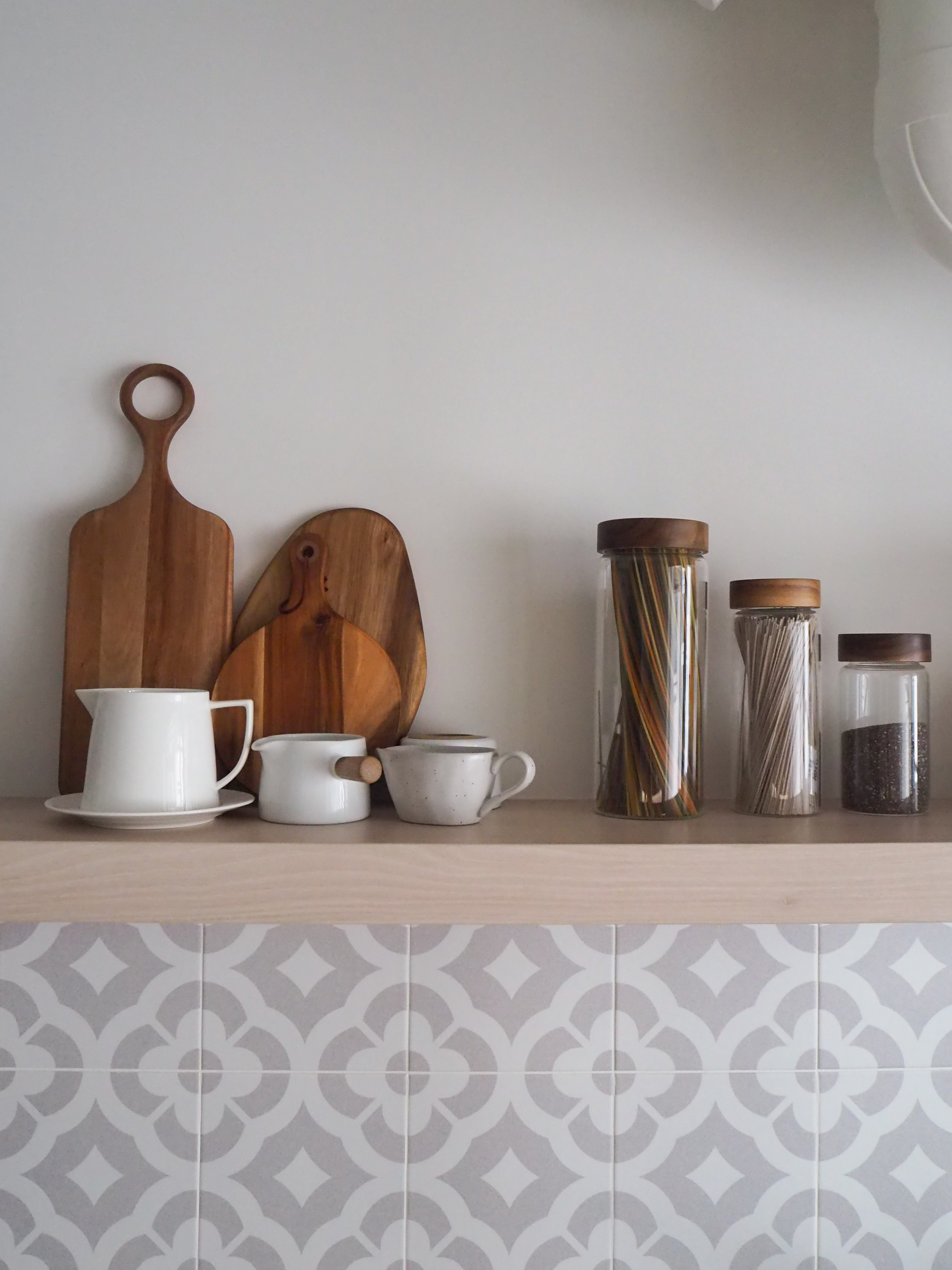 Our Galley Kitchen: 5 best reno decisions  - wooden cutting board, wooden utensil, white ceramic pitcher, white ceramic cup