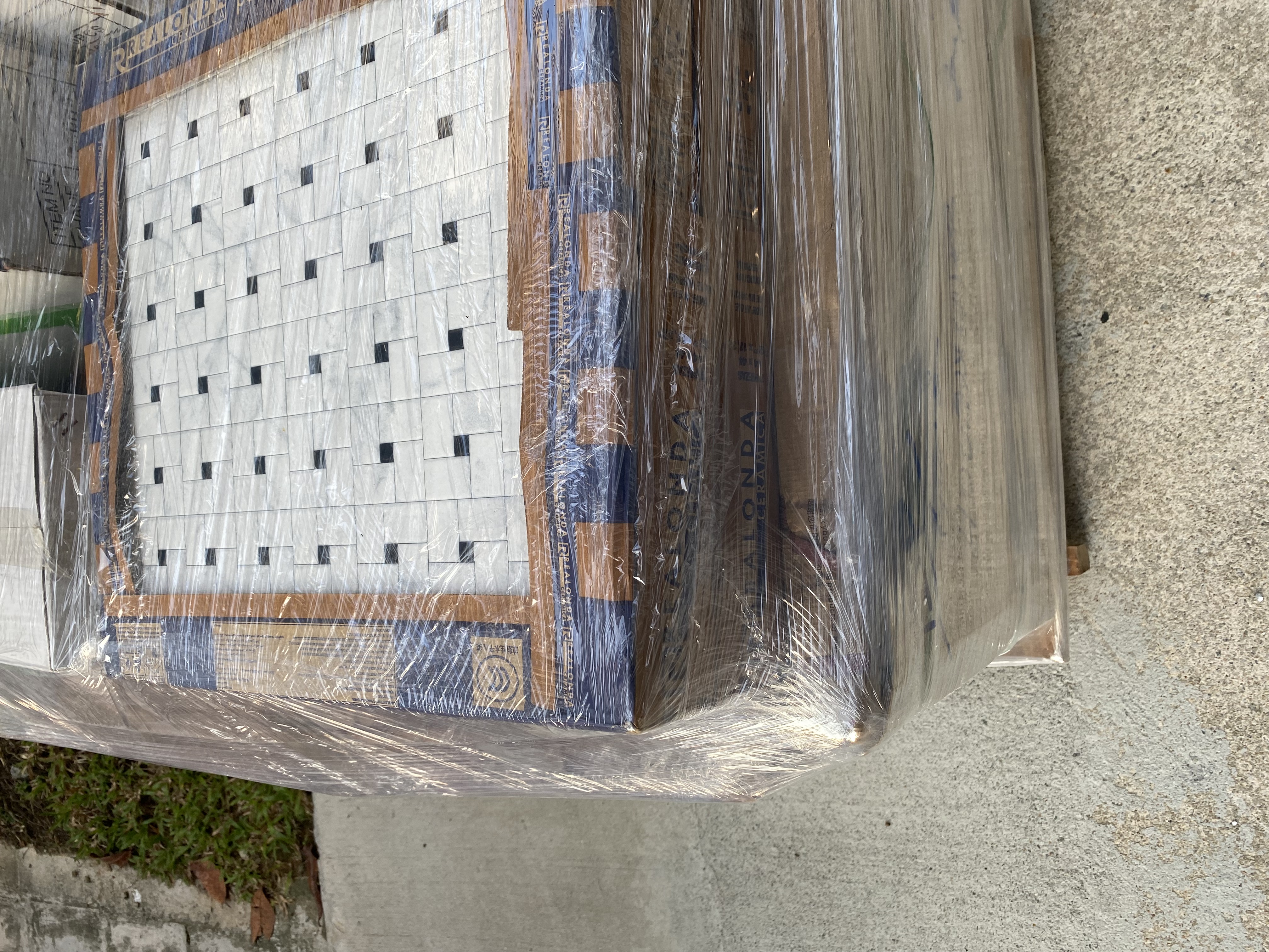 Our Bathrooms and their Personalities - Transparent plastic wrap covering a large, patterned tile, Construction site with a