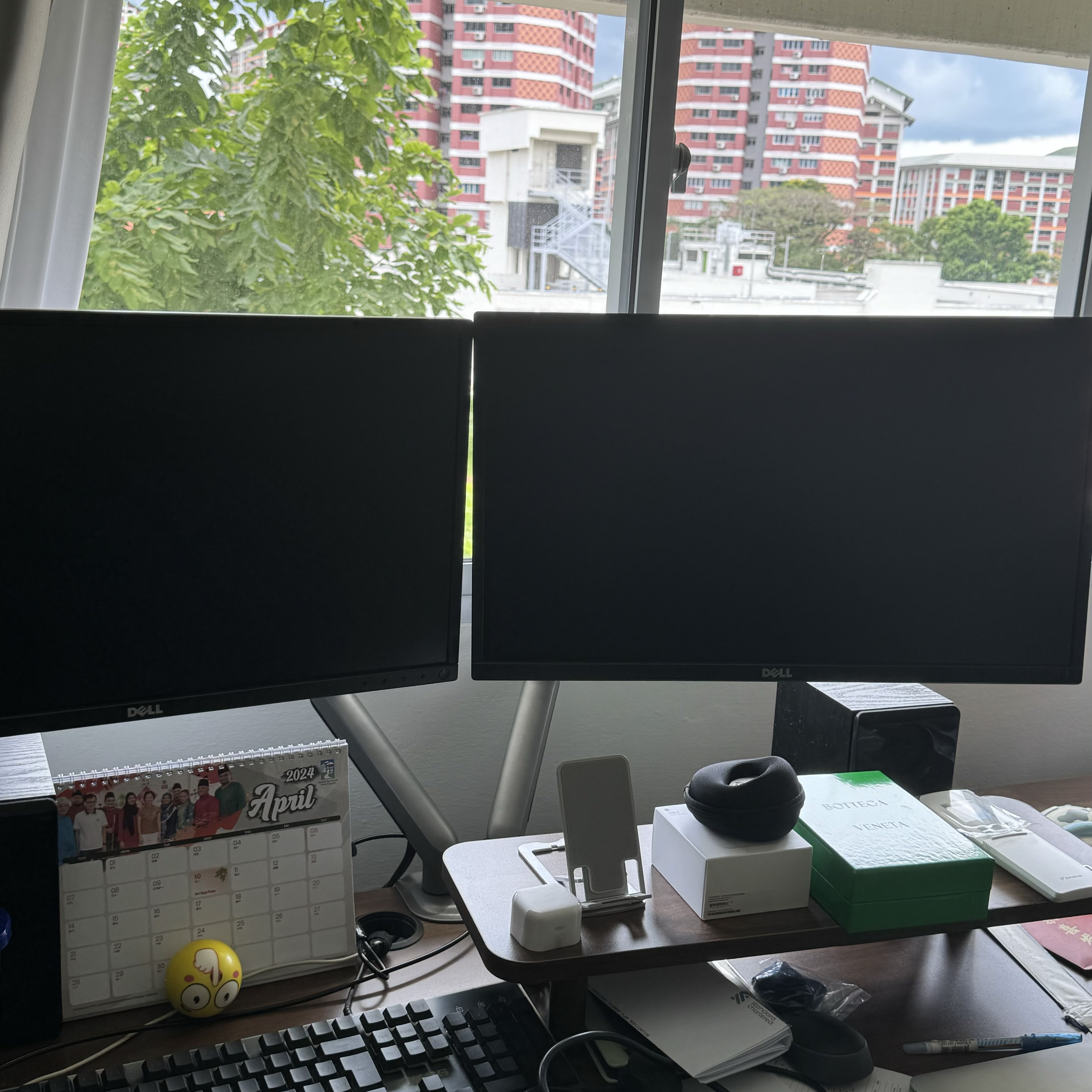 A tiny study room for the tiny tofus  - Dell monitors, calendar, April 2024, cluttered desk, black screens, office supplies