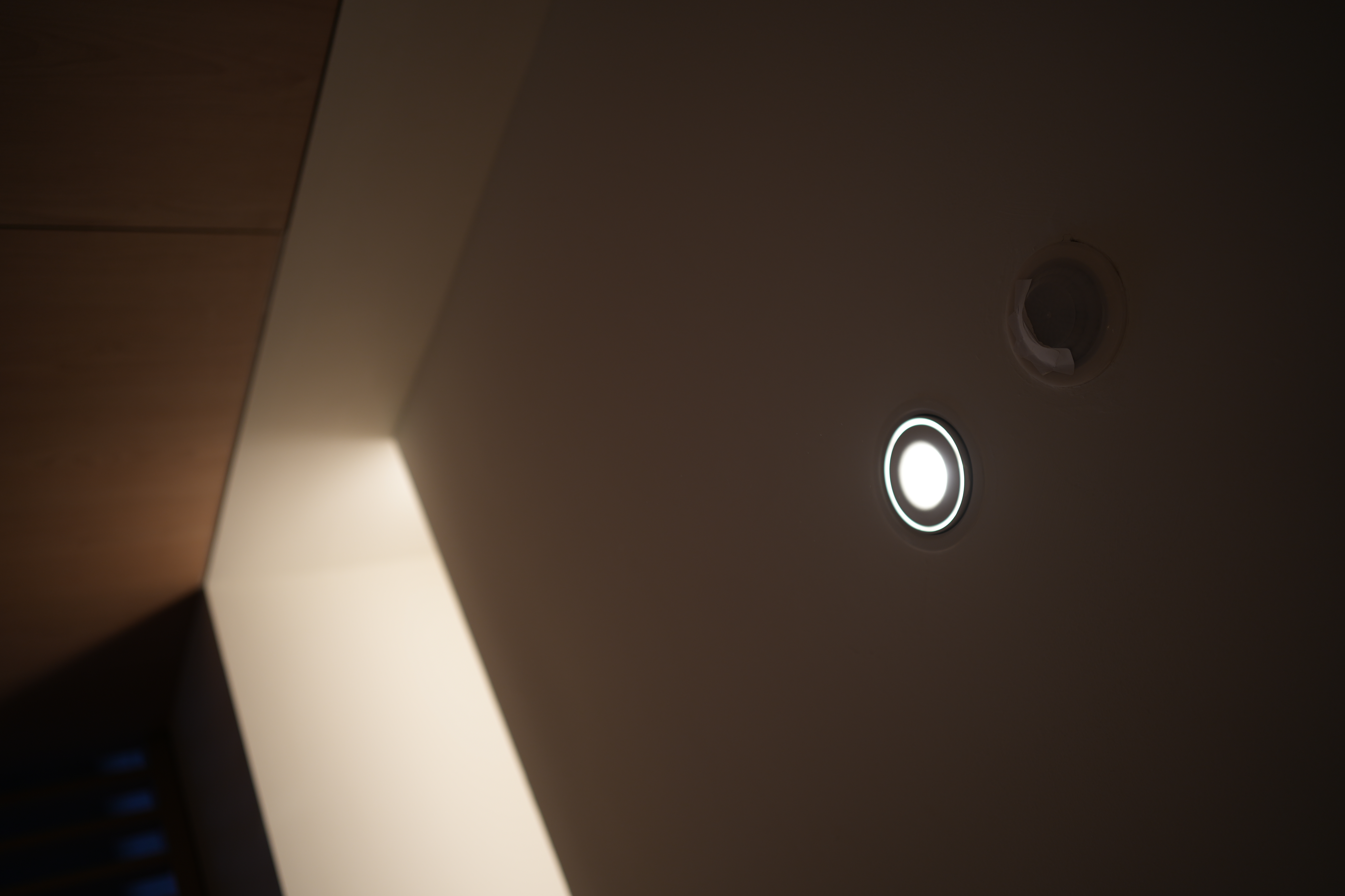 Choosing Lighting: Dimmables, Accents, Moods - Modern minimalist design, sleek ceiling light fixture, soft ambient lighting