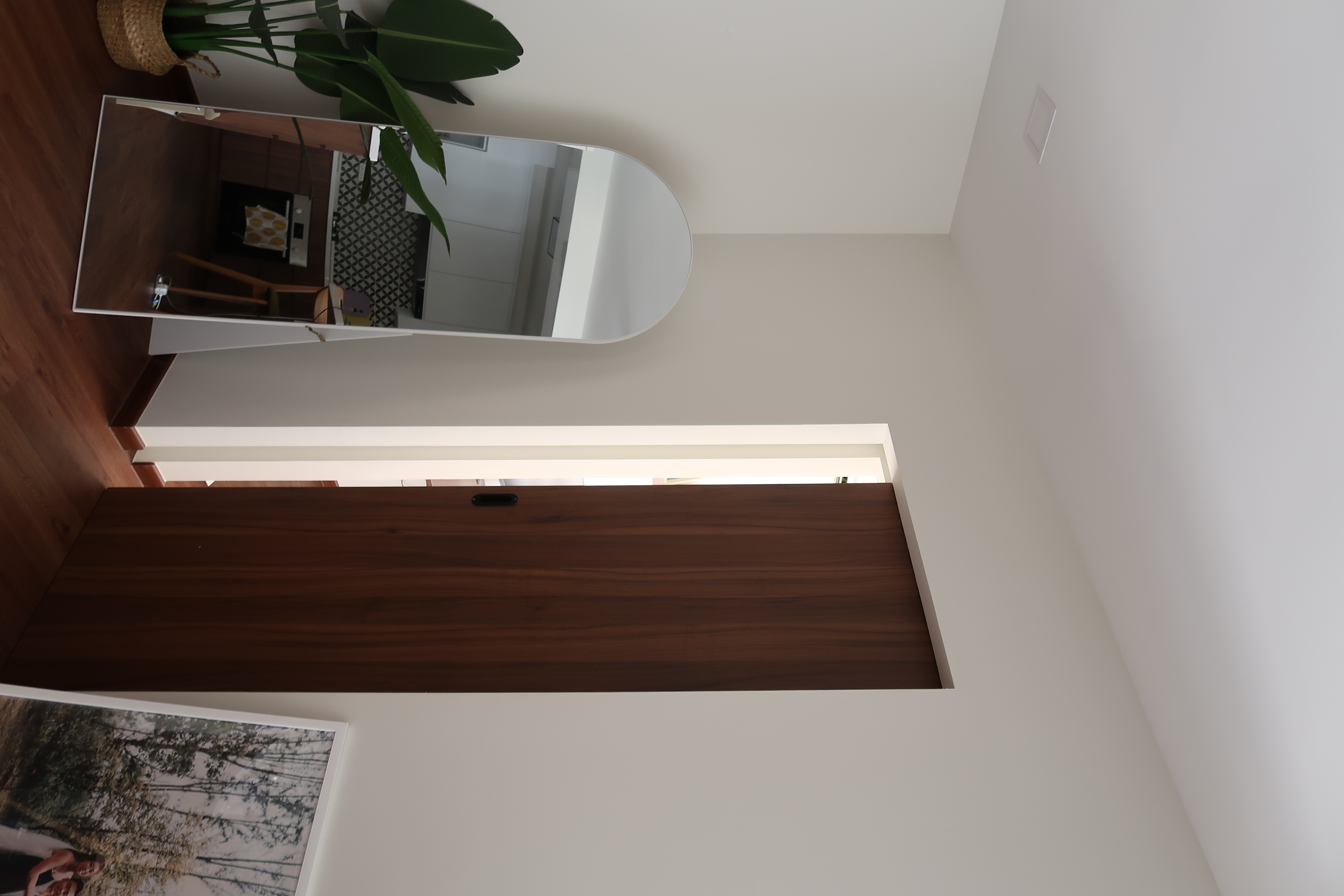 Workspace: We hacked our room into half  - Modern minimalist home interior, large mirror reflecting kitchen, wooden floor and