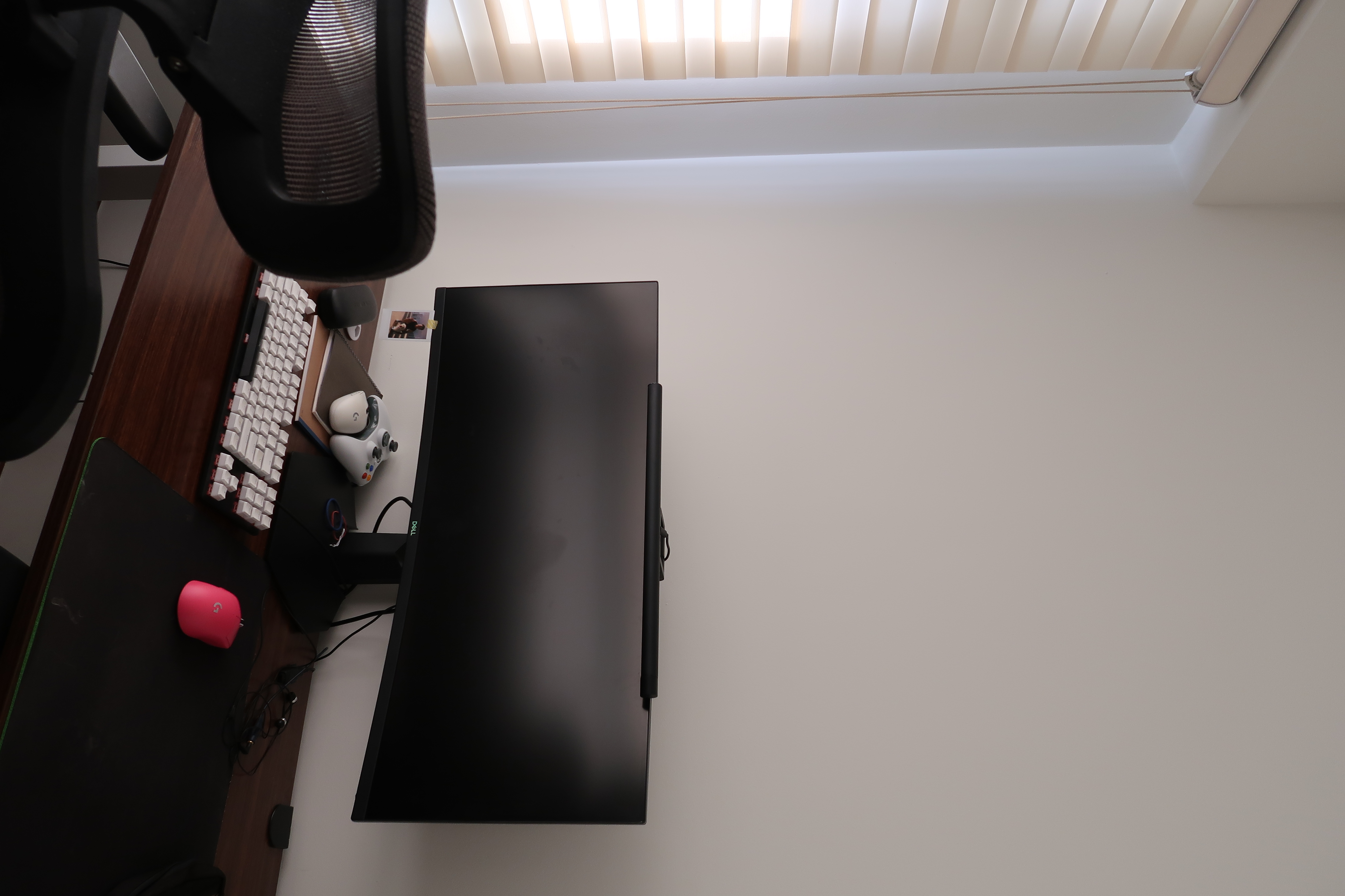 Workspace: We hacked our room into half  - Black desk with ergonomic chair, sleek monitor, ergonomic keyboard, gaming mouse