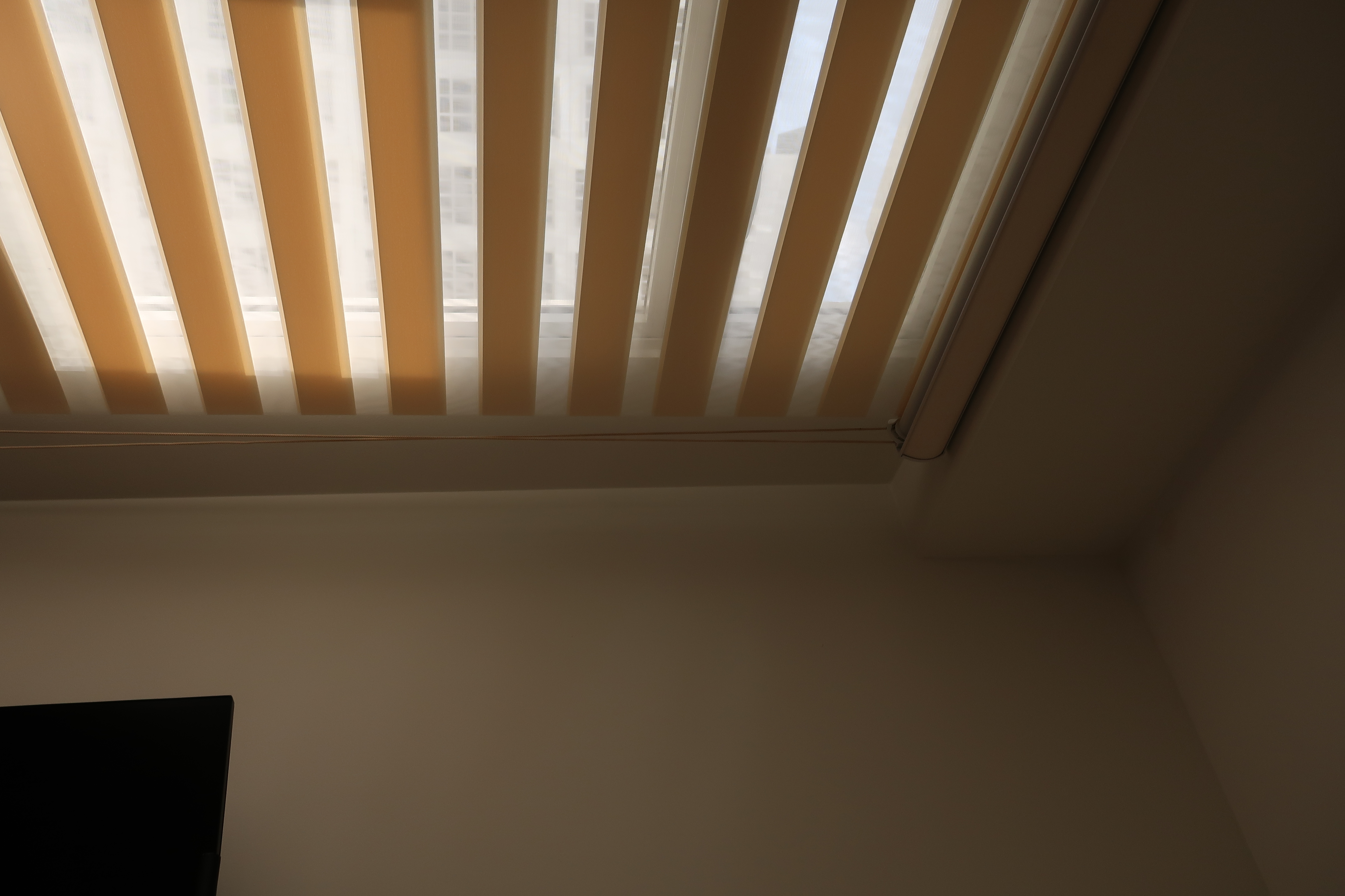 Workspace: We hacked our room into half  - Sunlight filtering through beige blinds, ceiling with white beams, room with beige