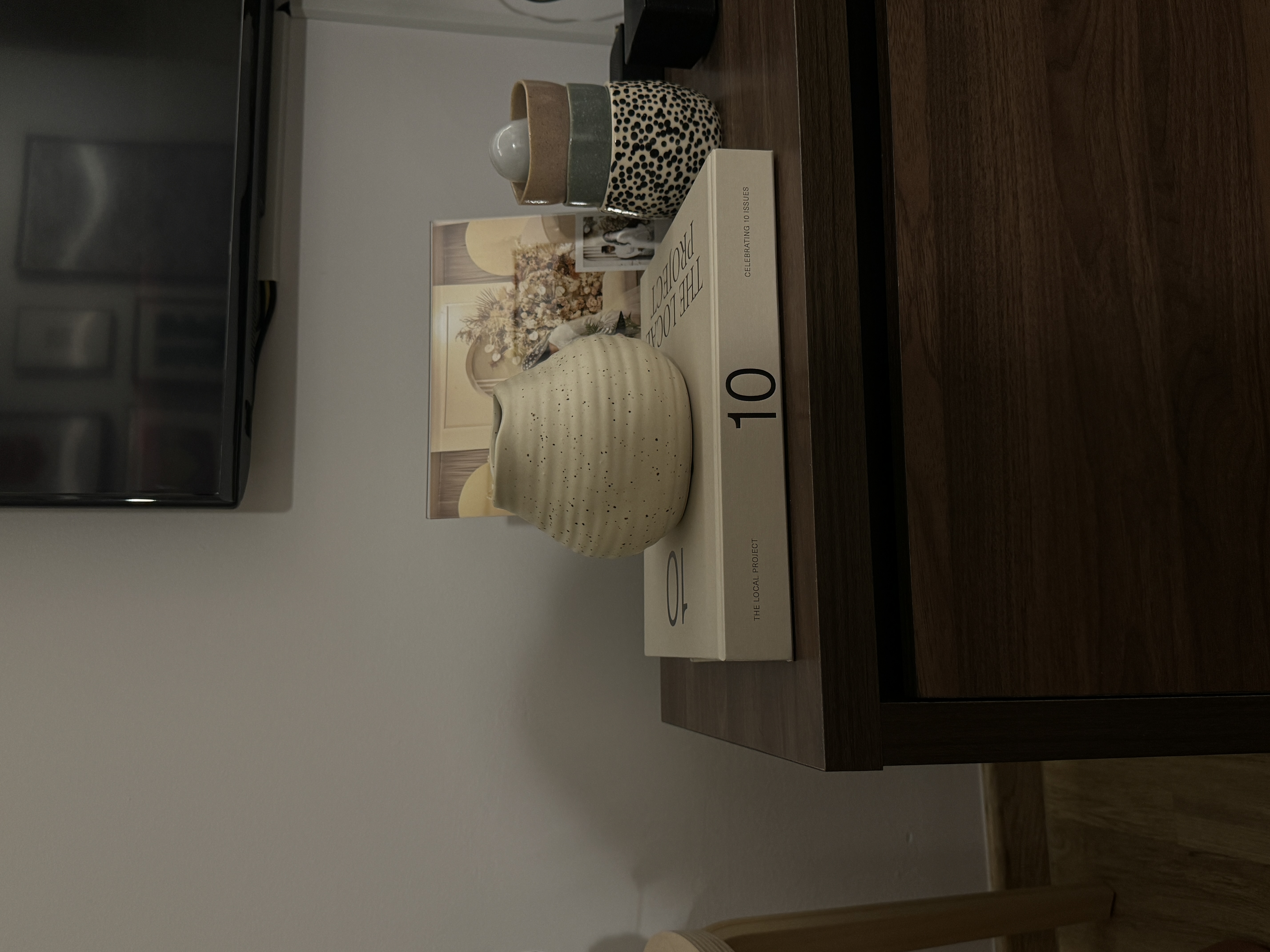 A characterful living room - vintage ceramic vase, beige textured vase, leopard print container, modern decor, bookshelf