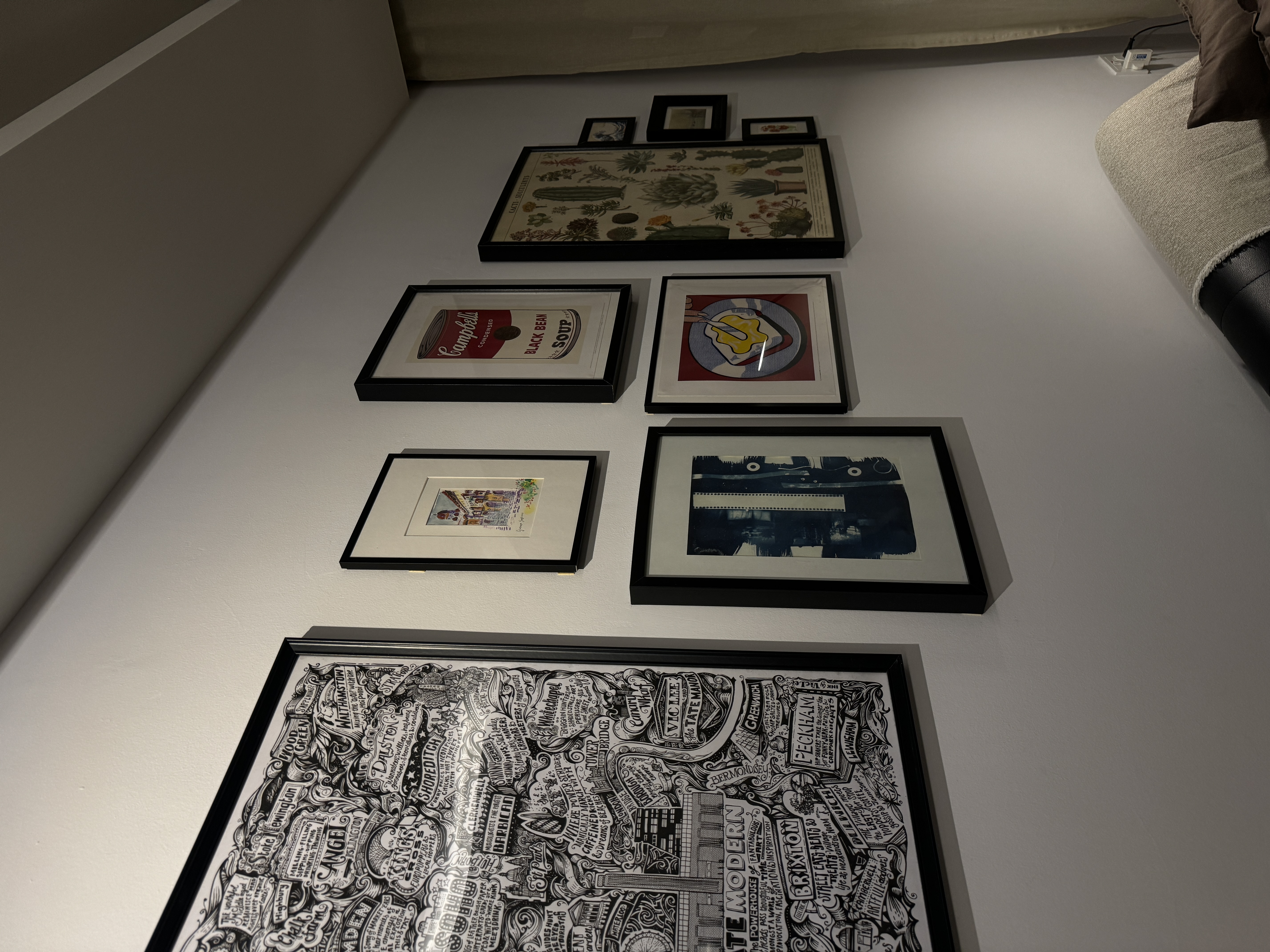 A characterful living room - Vintage framed artwork on white wall, Black and white illustration on wall, Artwork featuring