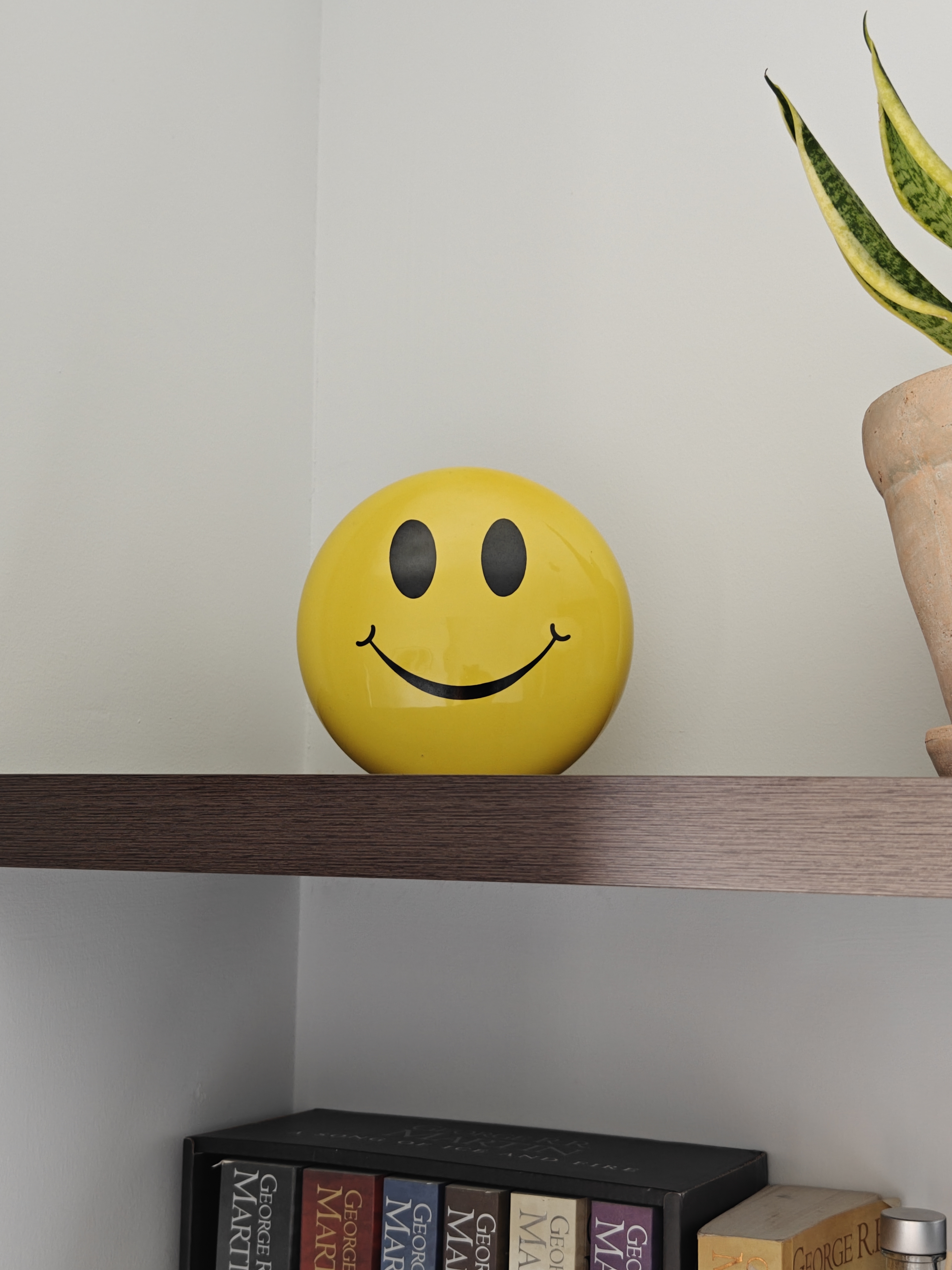 Work Where You Sleep! - Yellow smiley face, minimalist shelf, books on shelf, black and gold bookshelf, green and yellow