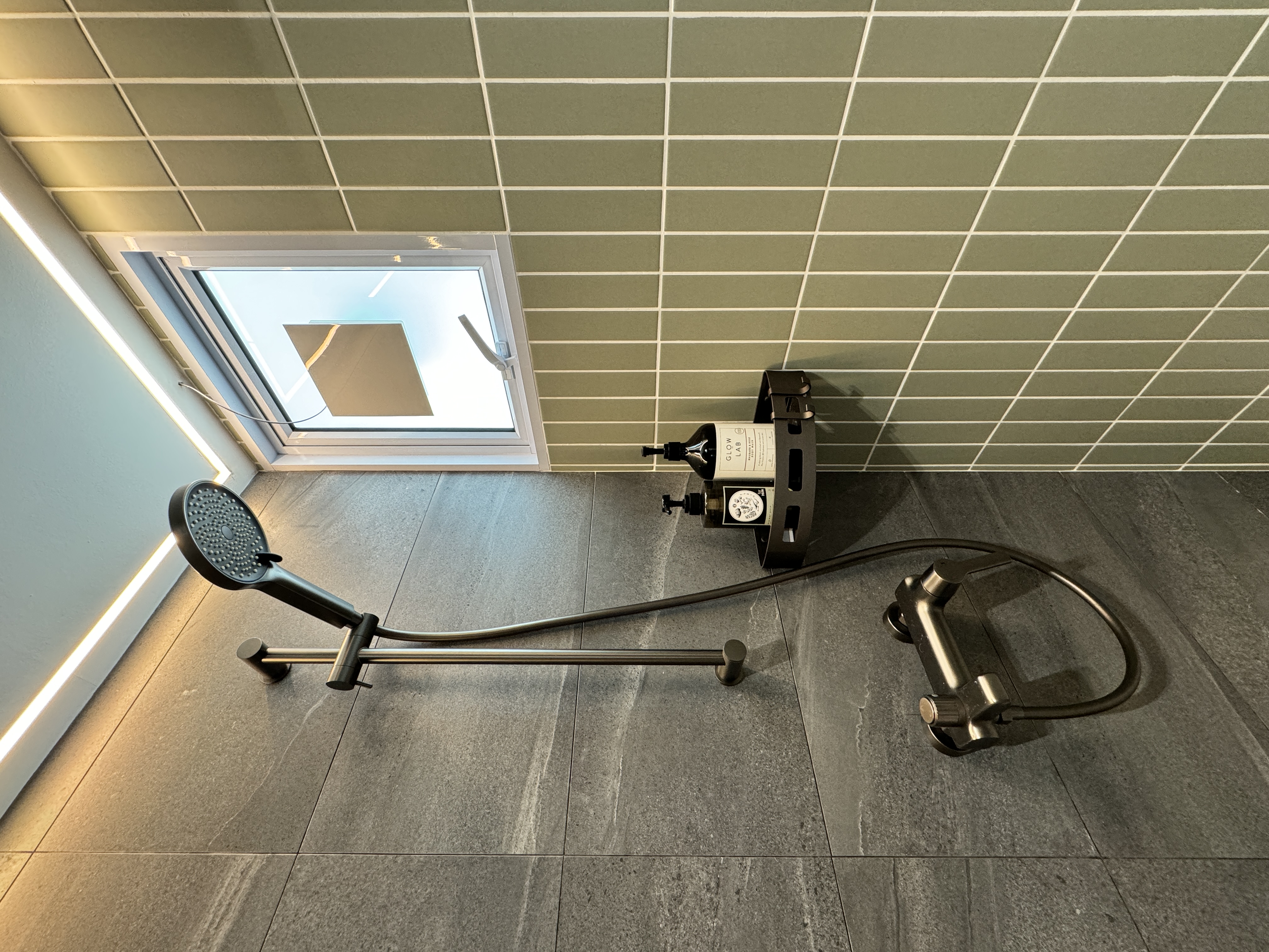 From Inspiration to Installation: The Story Behind Our Guest Bathroom - Modern bathroom corner, sleek fixtures, gray tiles