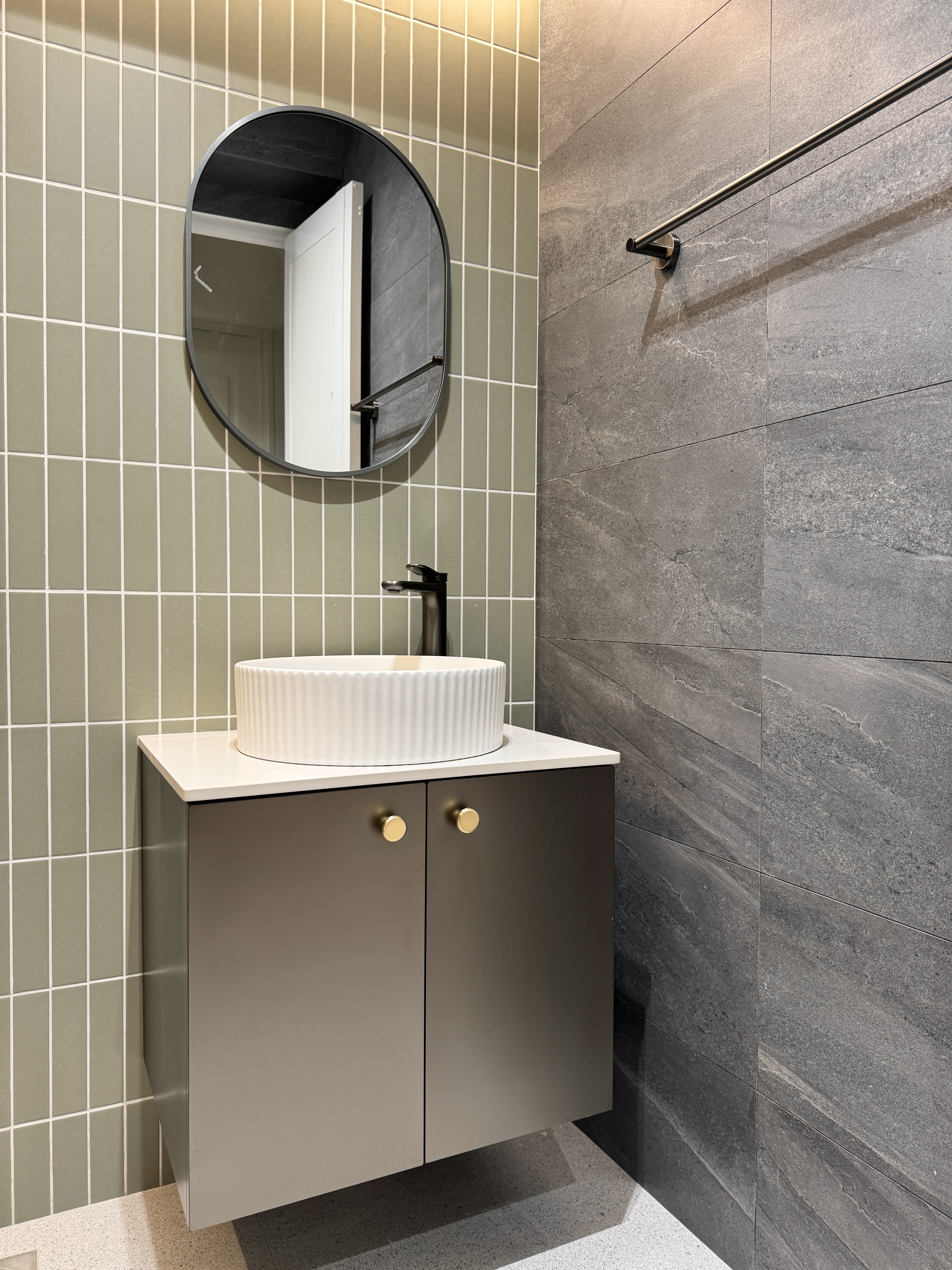 From Inspiration to Installation: The Story Behind Our Guest Bathroom - modern bathroom vanity, sleek sink, round mirror