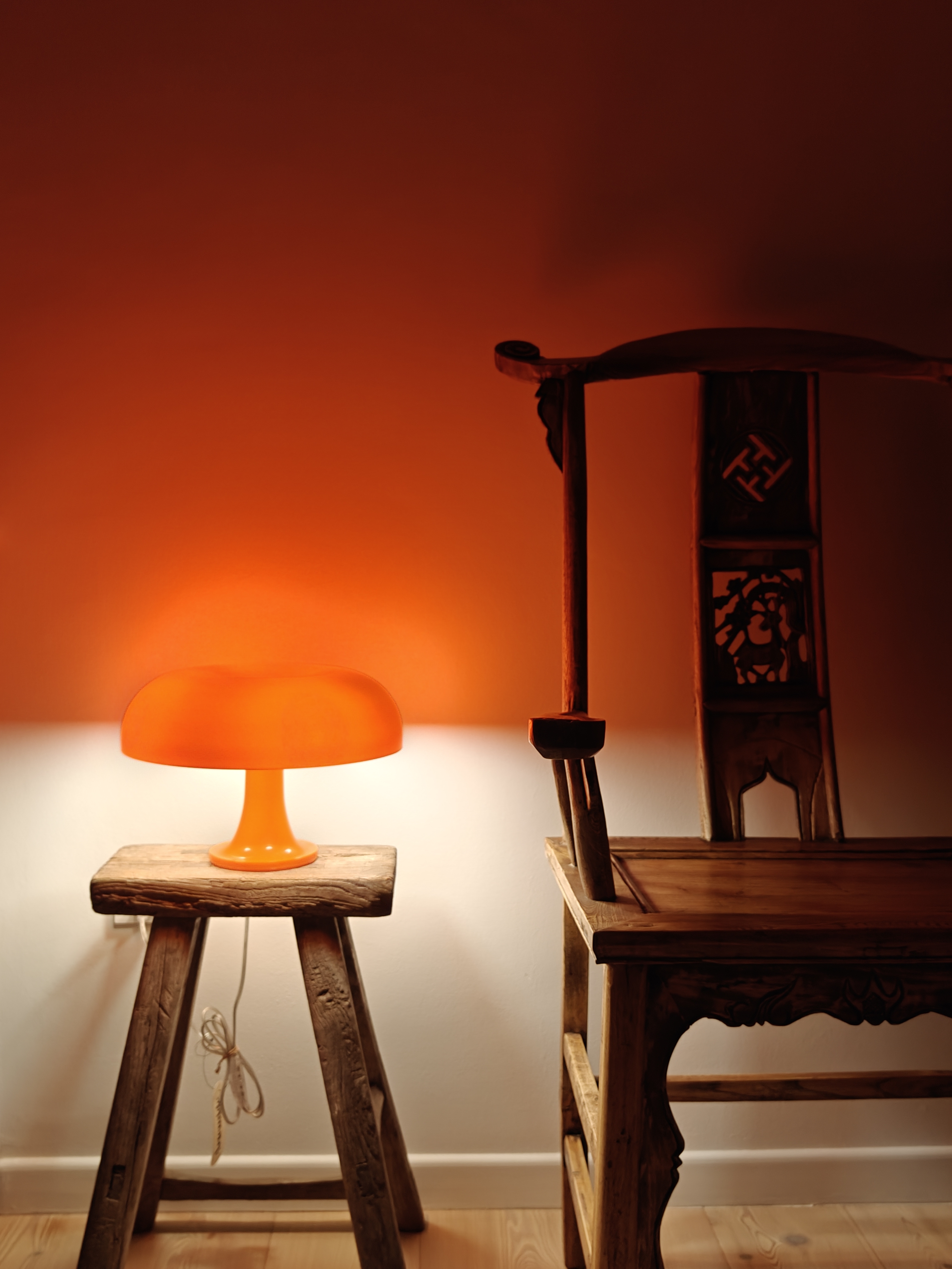 You Light Up My Life! - Lamp with orange shade, wooden stool, rustic ambiance, warm lighting, wooden chair, intricate
