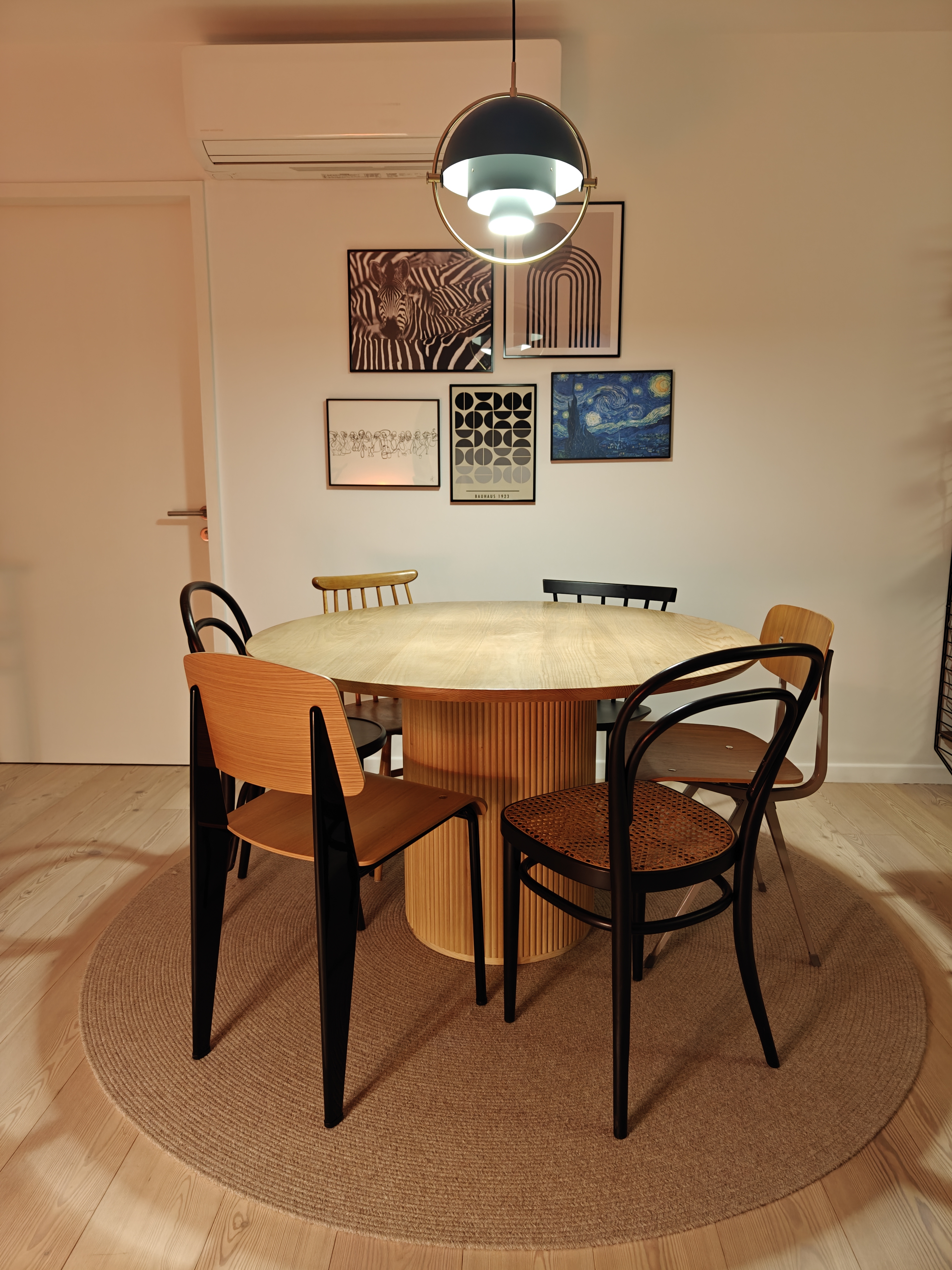 You Light Up My Life! - Modern dining room, minimalist design, round table, wooden chairs, black metal frame, abstract art