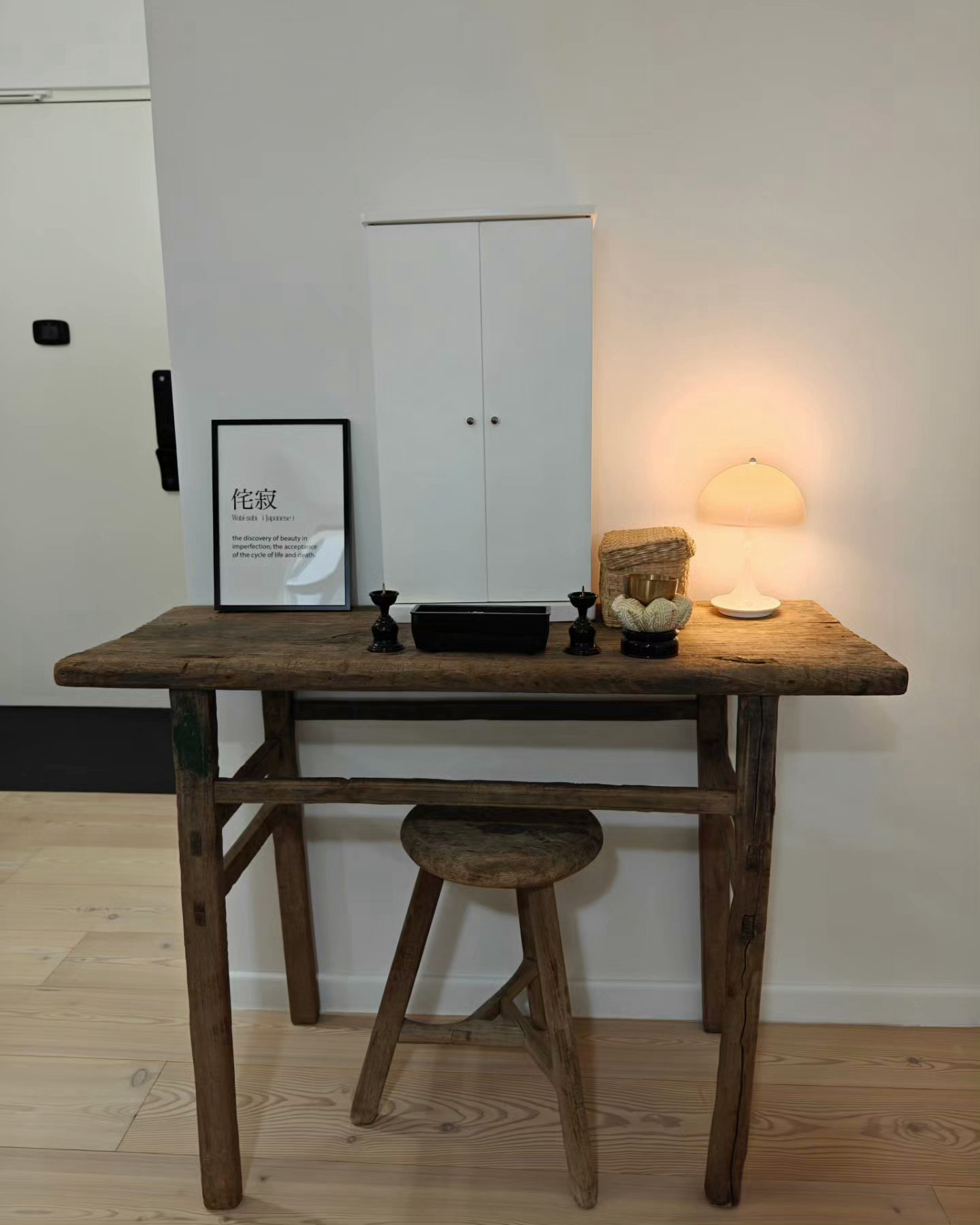 You Light Up My Life! - rustic wooden table, rustic wooden stool, wooden floor, white cabinet, black candle holder, black