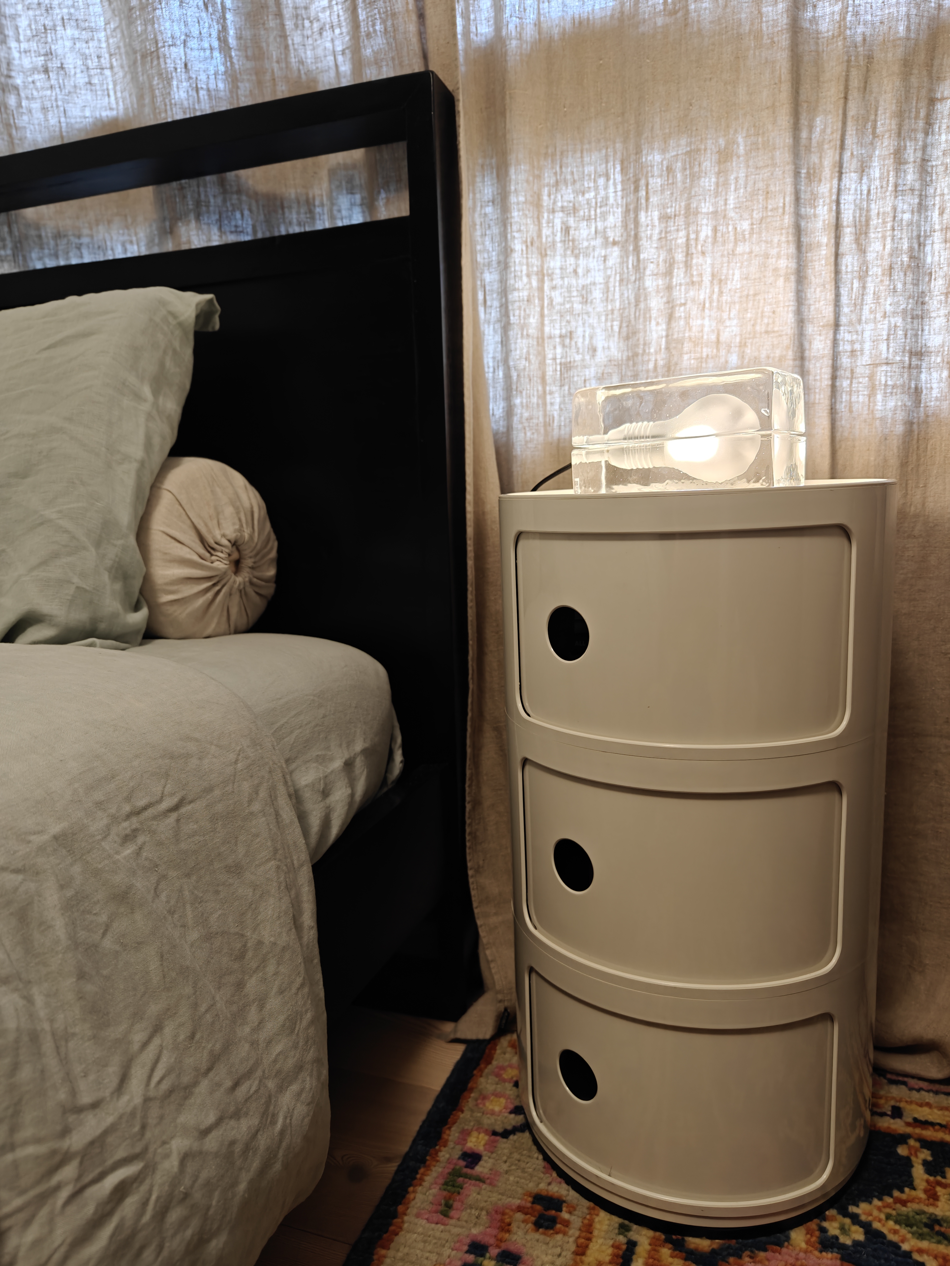 You Light Up My Life! - Bedside nightstand, beige curtains, soft lighting, cozy room, bedside table, white drawers, textured