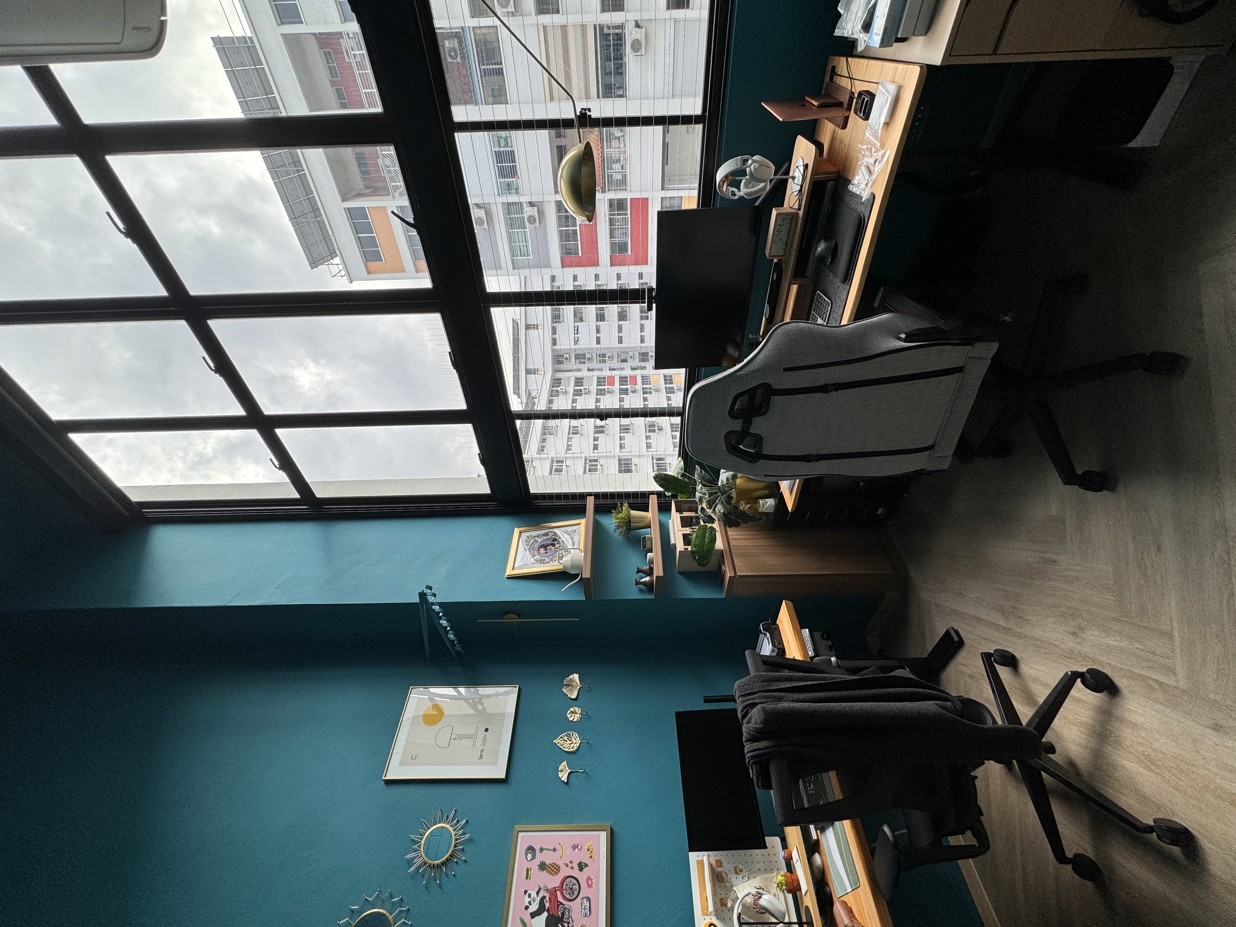 A chic turquoise study with dramatic double-volume windows - Large glass windows, urban view, office space, modern decor