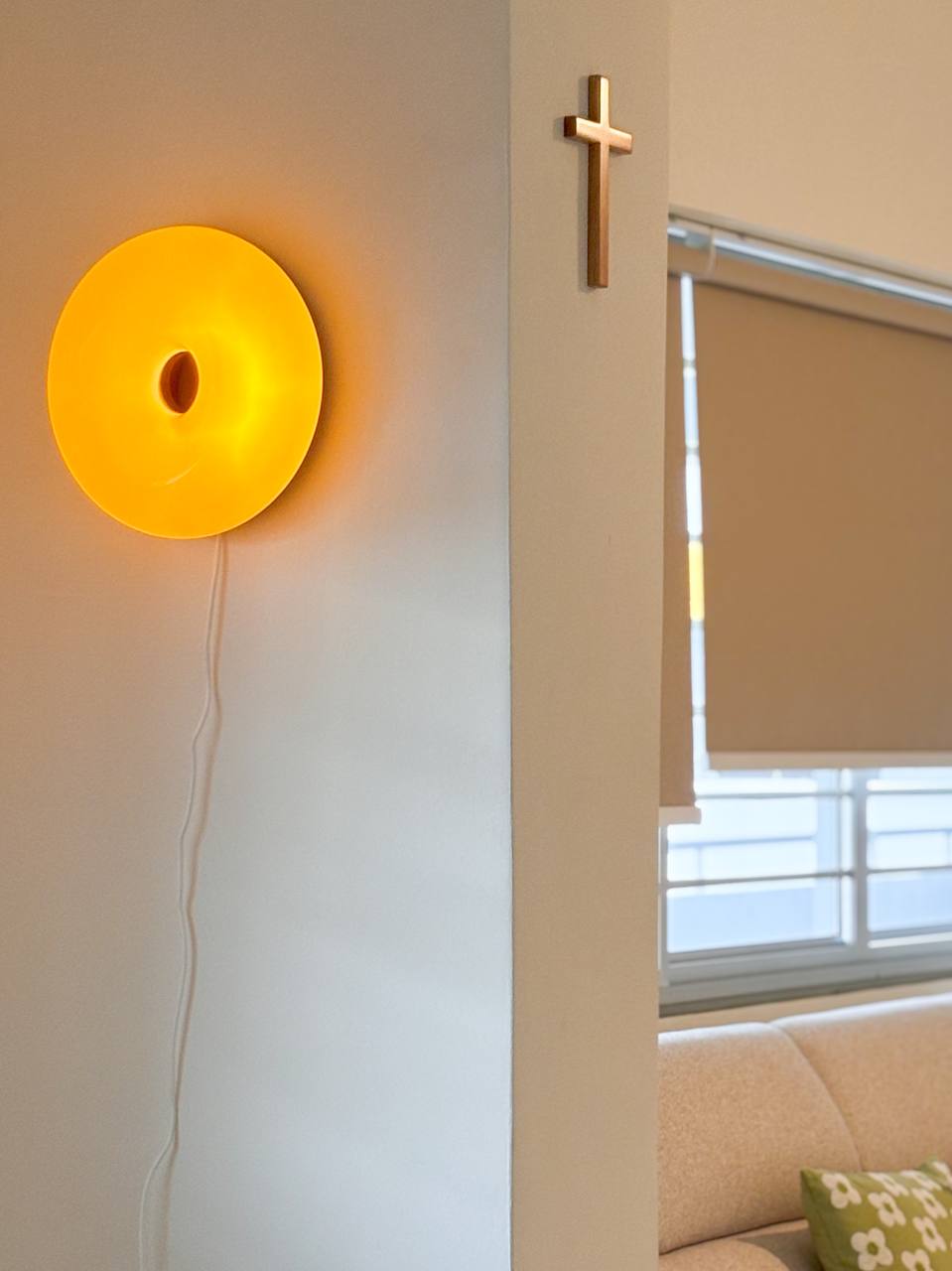 Good Lighting Makes Your House a Home  - Modern minimalist decor, yellow circular light fixture, white wall, beige couch