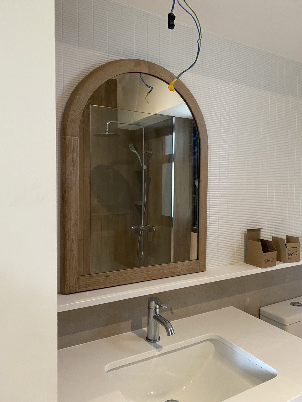 Bathroom: Creating textures through tiles - Wooden-framed mirror, modern bathroom, glass shower enclosure, sleek sink