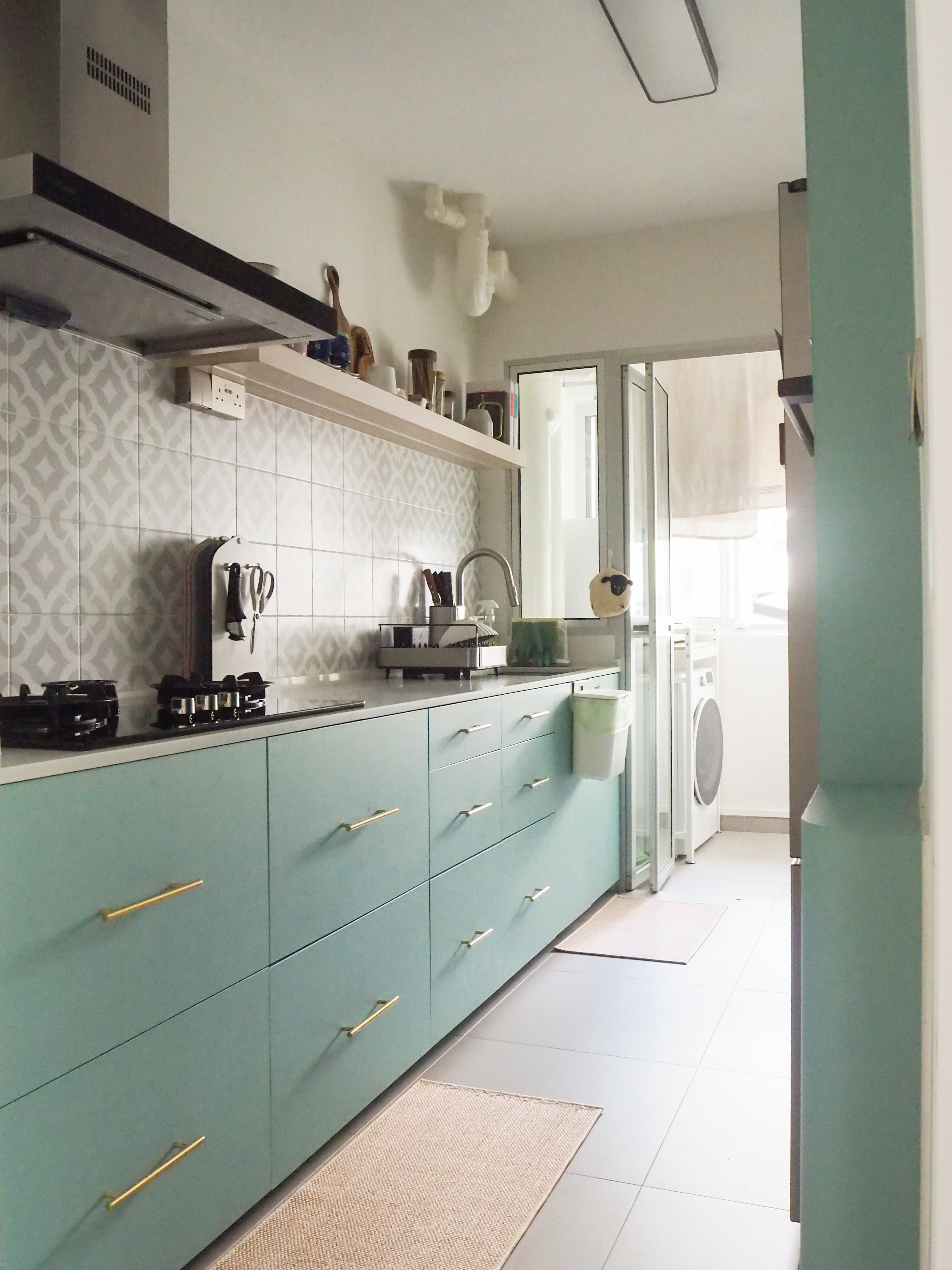 Our Galley Kitchen: 5 best reno decisions  - Modern kitchen with teal cabinets and gold handles, white tiled backsplash