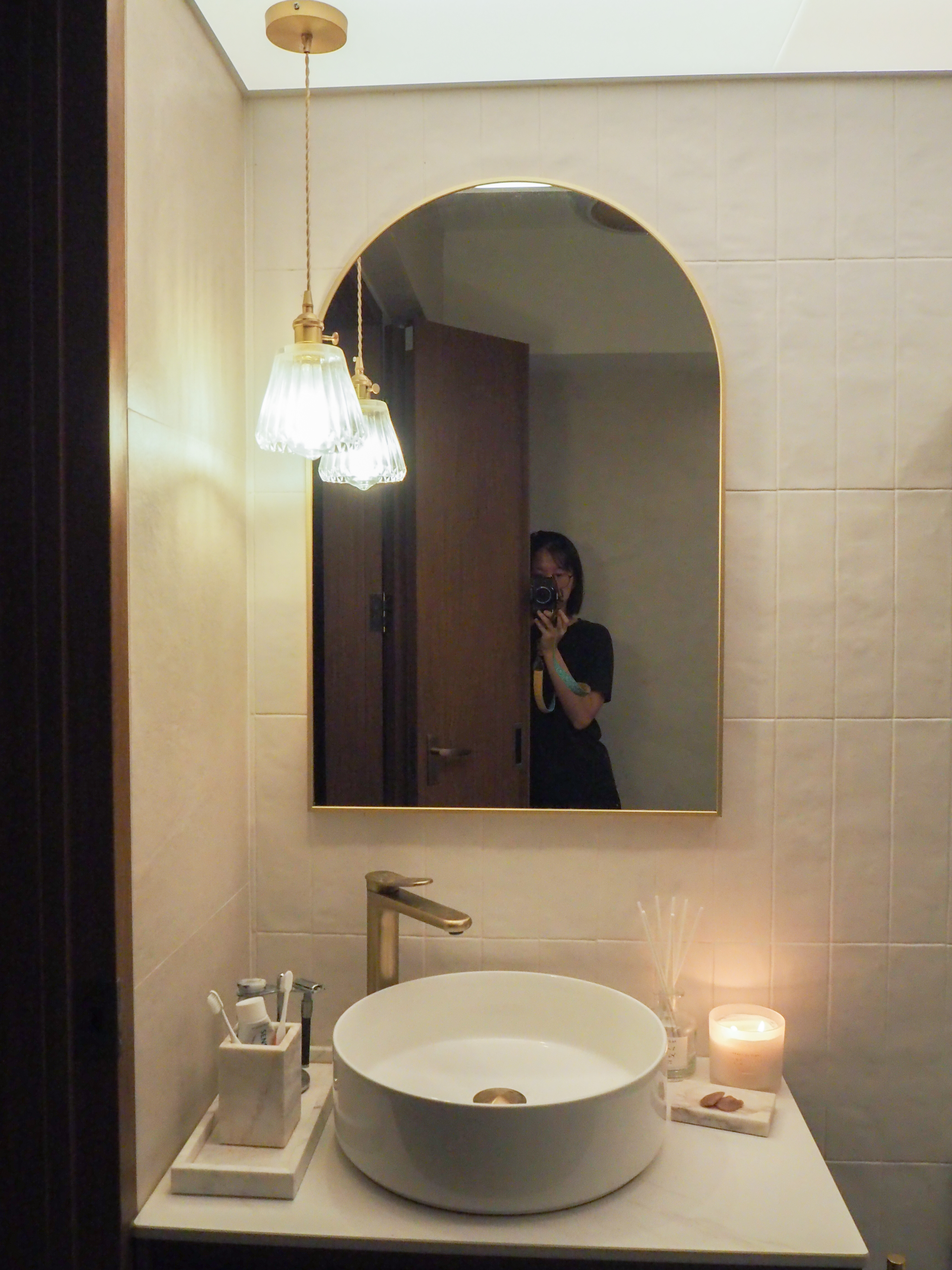 Our vibrant and subtle Mid-Century Modern Boho bathrooms - Bathroom vanity, white sink, gold faucet, wooden door, elegant