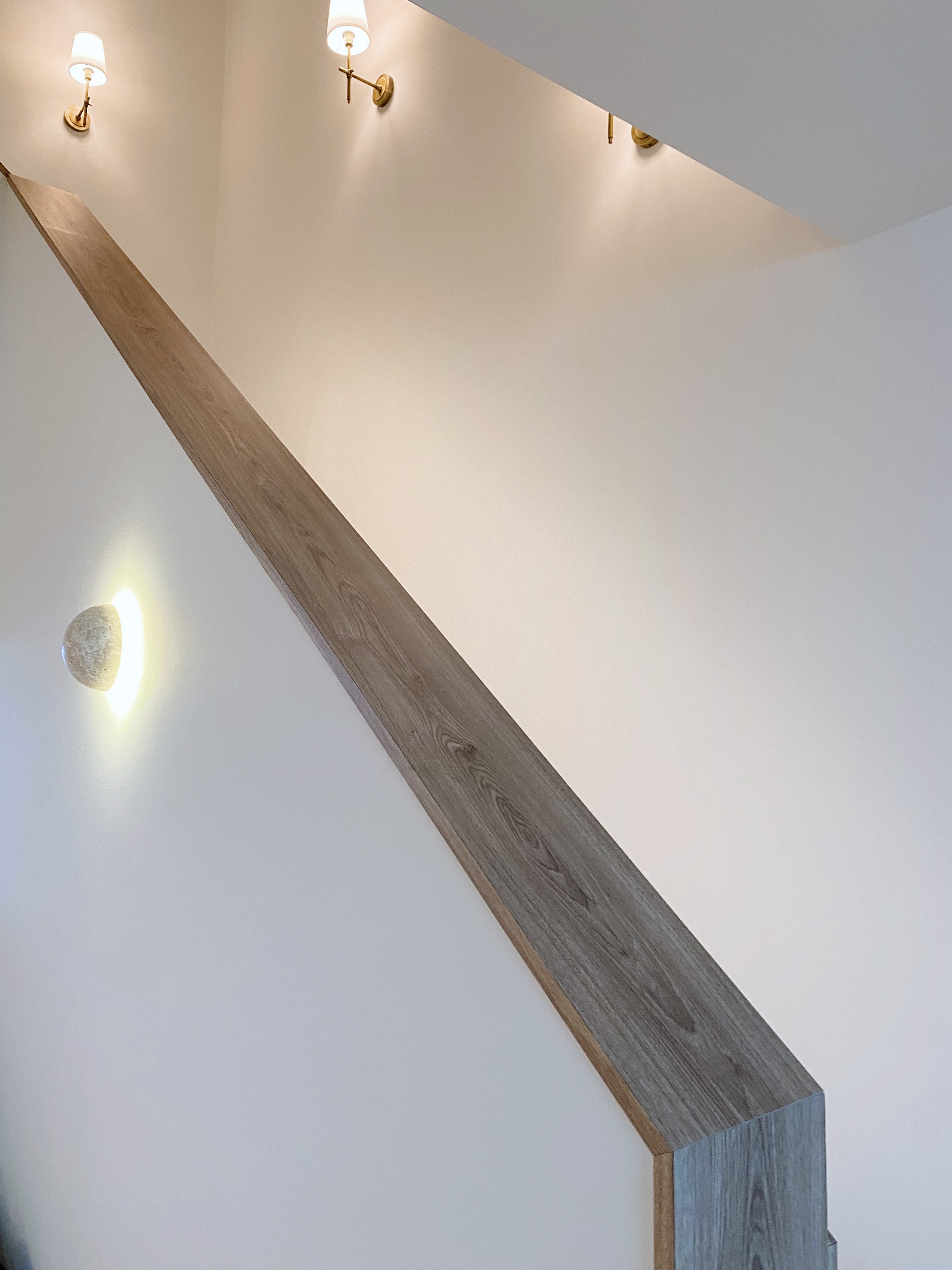 (work in place) doorways and corridors  - Wooden staircase with modern lighting fixtures, minimalist design, sleek finish
