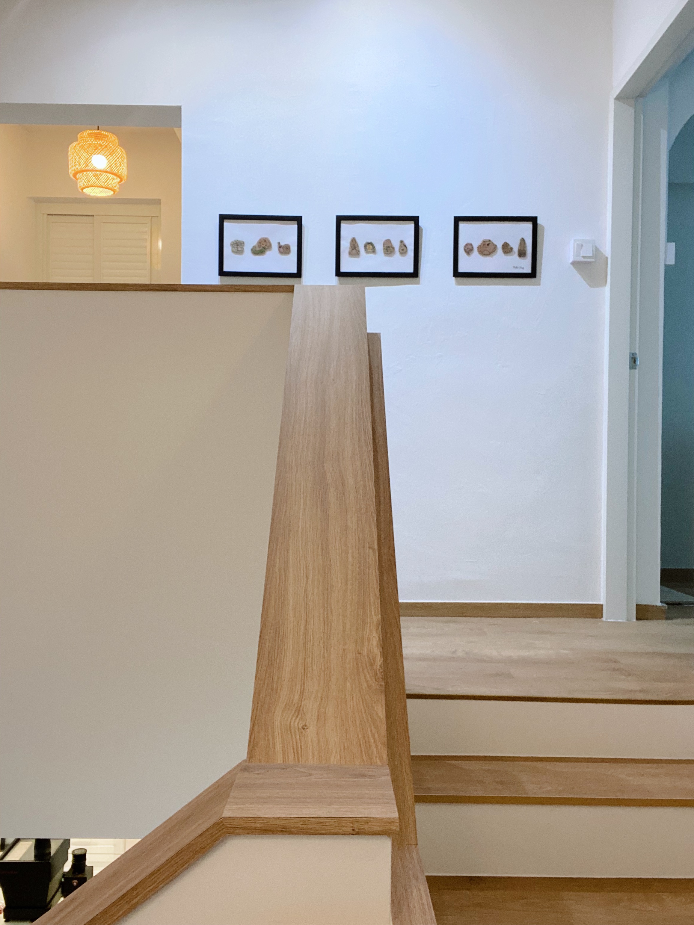 (work in place) doorways and corridors  - Modern staircase with wooden handrail, minimalist art pieces on white wall, warm