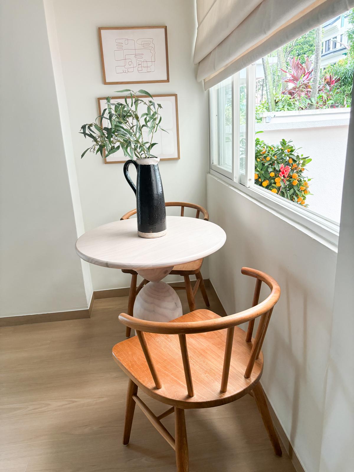 A welcoming and warm entryway  - Modern minimalist dining room, white marble table, wooden chairs, natural light streaming