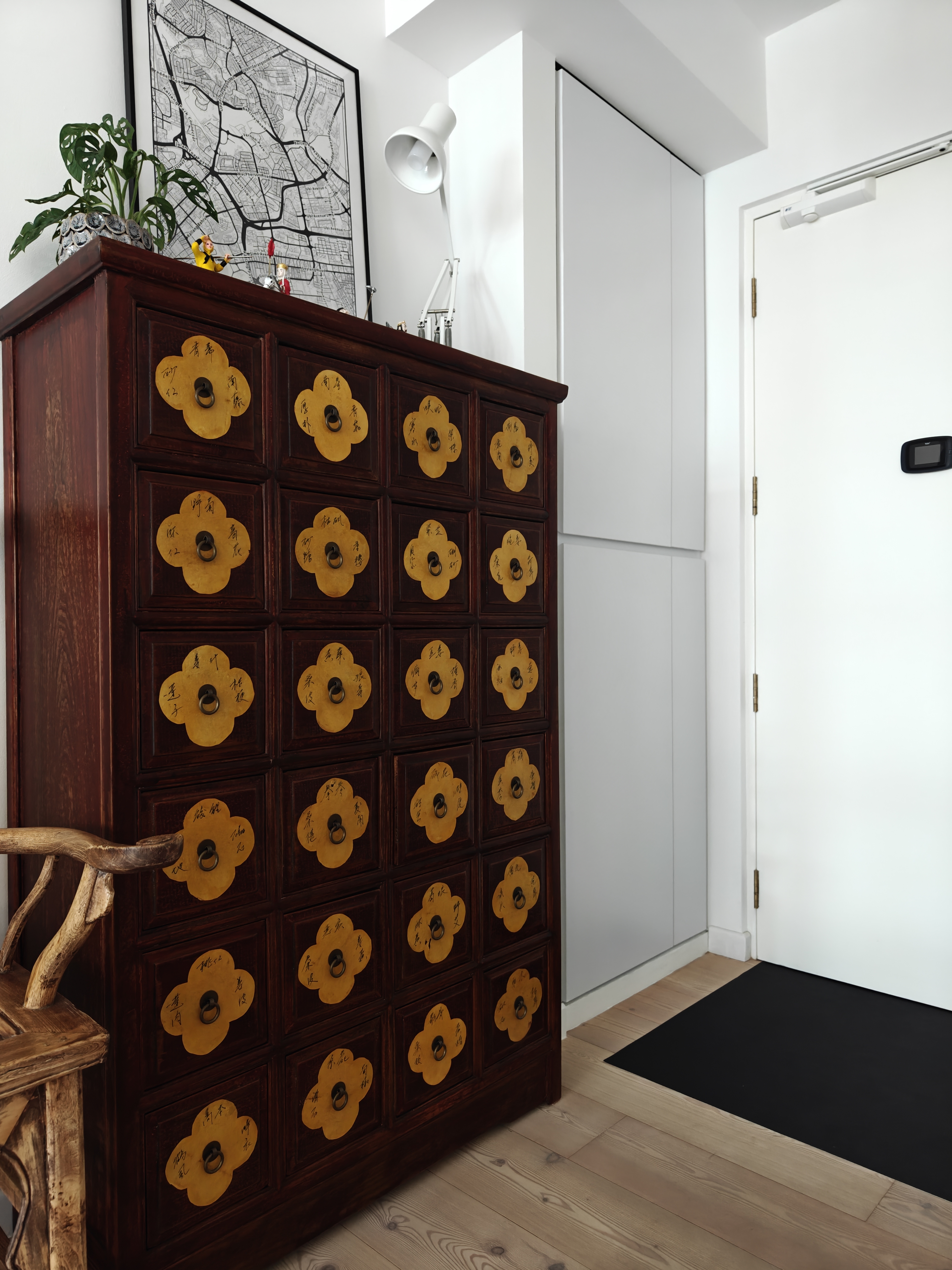 The Entry To Our World - Wooden cabinet with flower-shaped handles, dark brown wood, intricate design, yellow handles