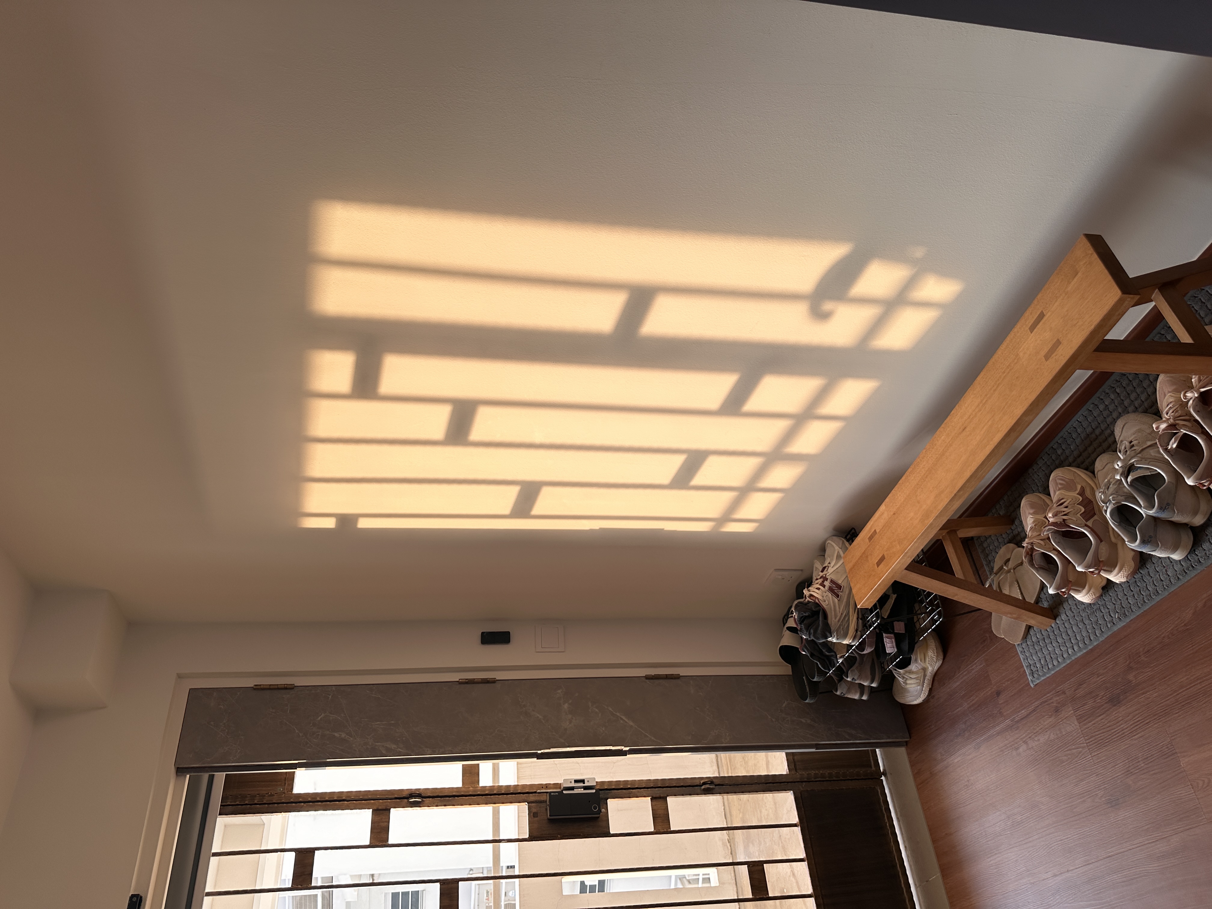 Entryway: Functional and well thought walkway into our home  - Sunlight streaming through slatted window coverings, casting