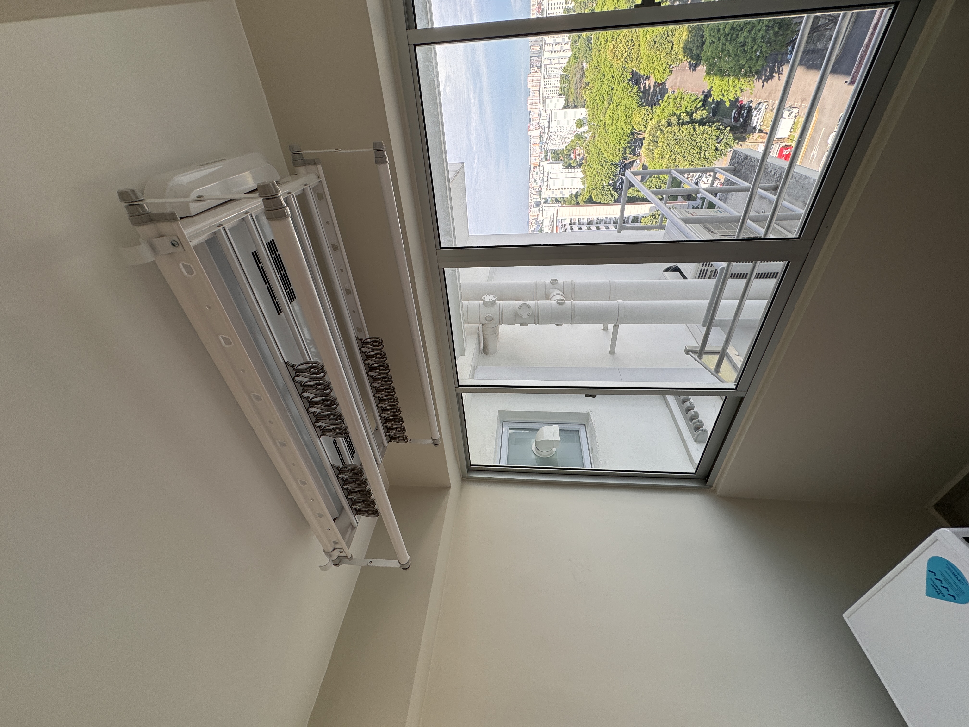 Welcome to the Service Yard Tour! - Large window, interior view, balcony, exterior cityscape, green trees, urban environment