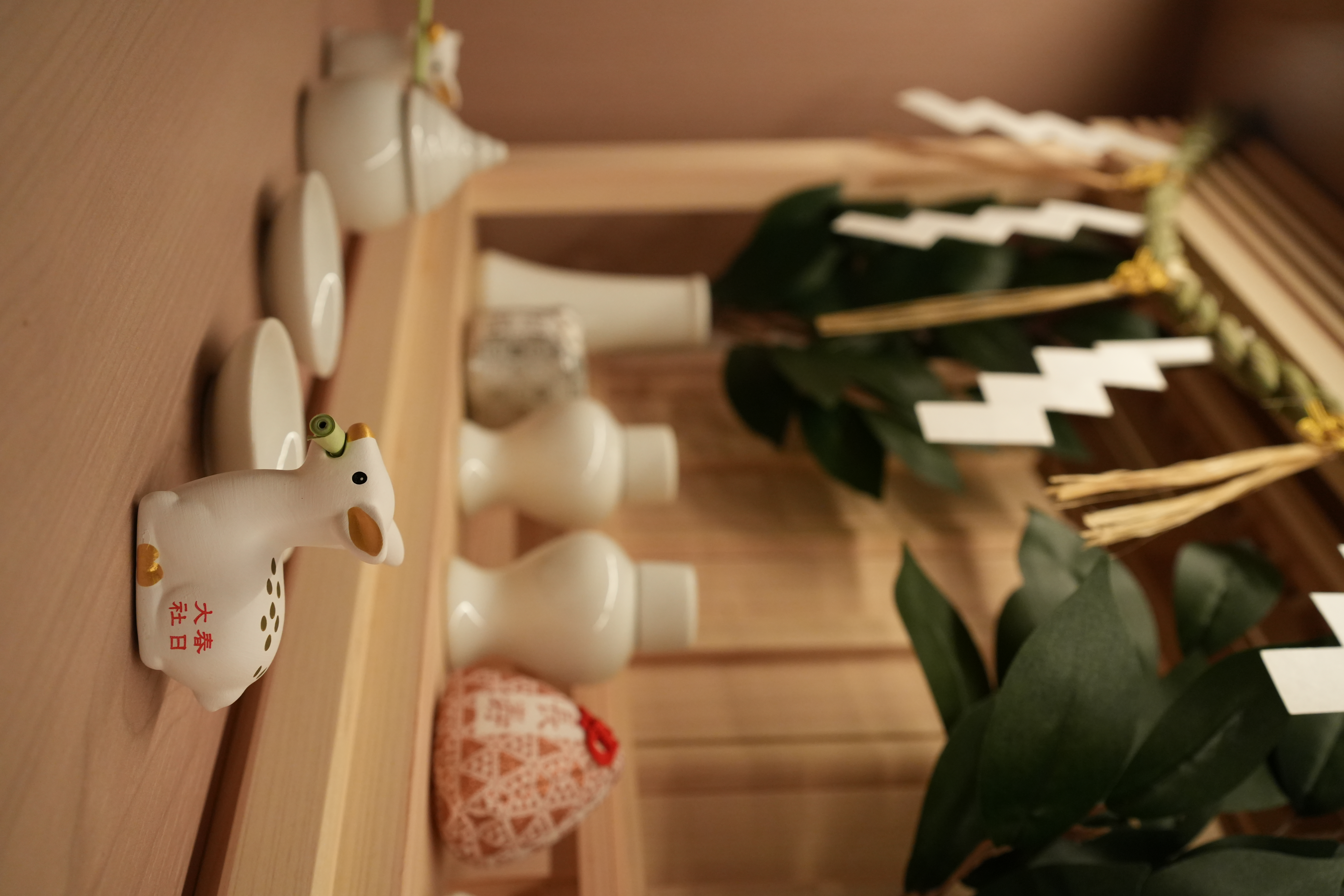 What we love about our Modern Japanese home - White ceramic pig-shaped object with green eyes and gold accents, Chinese